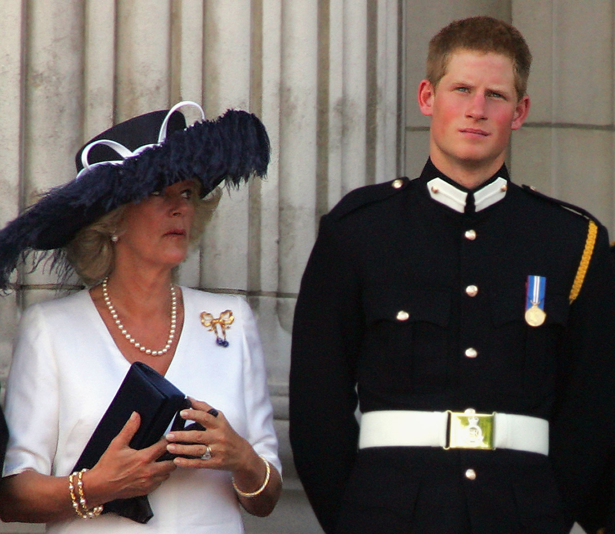 Camilla Parker Bowles and Prince Harry standing on Buckingham Palace balcony for a flypast