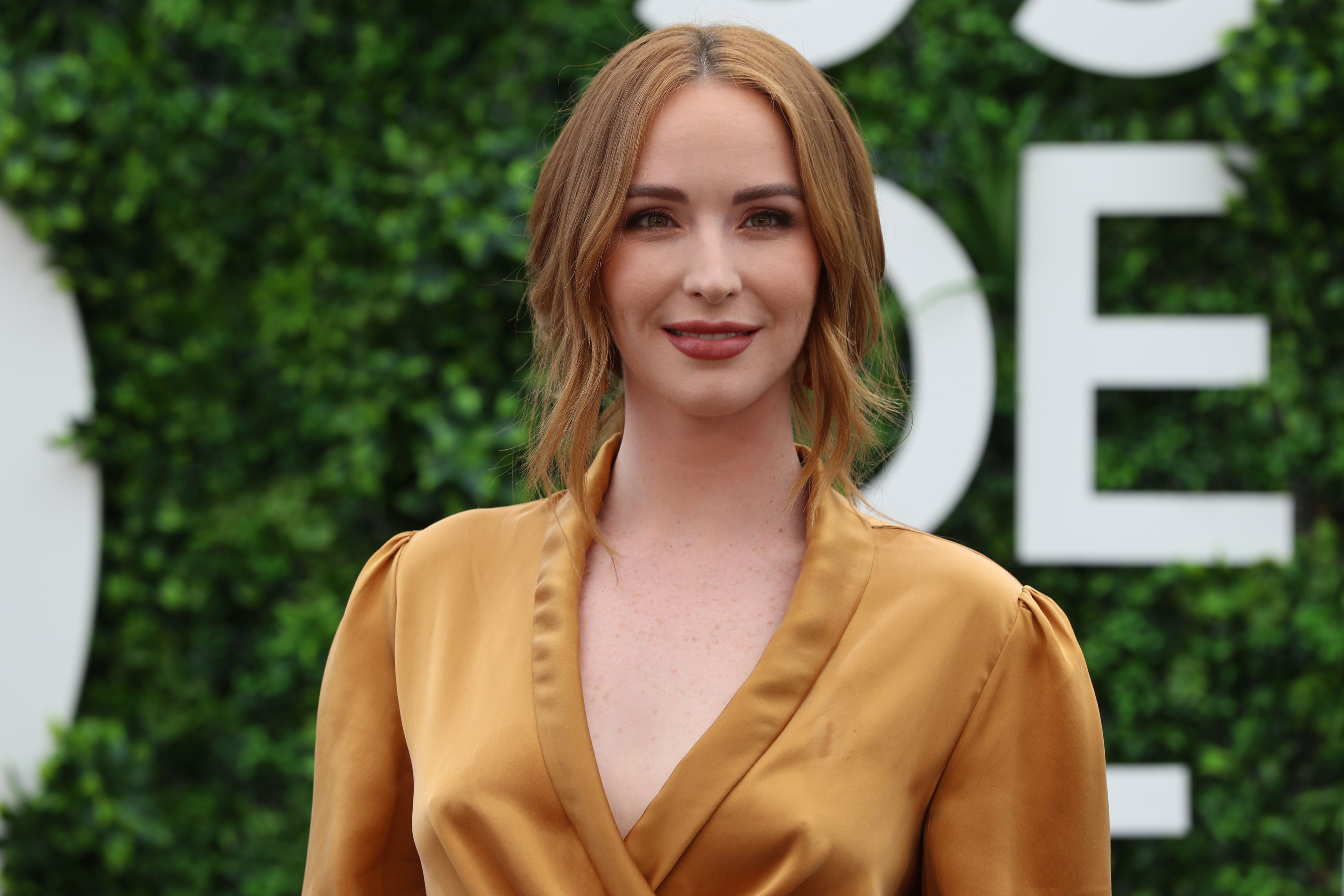 'The Young and the Restless' actor Camryn Grimes wearing a gold dress and posing on the red carpet at the 2019 Monte Carlo TV Festival.