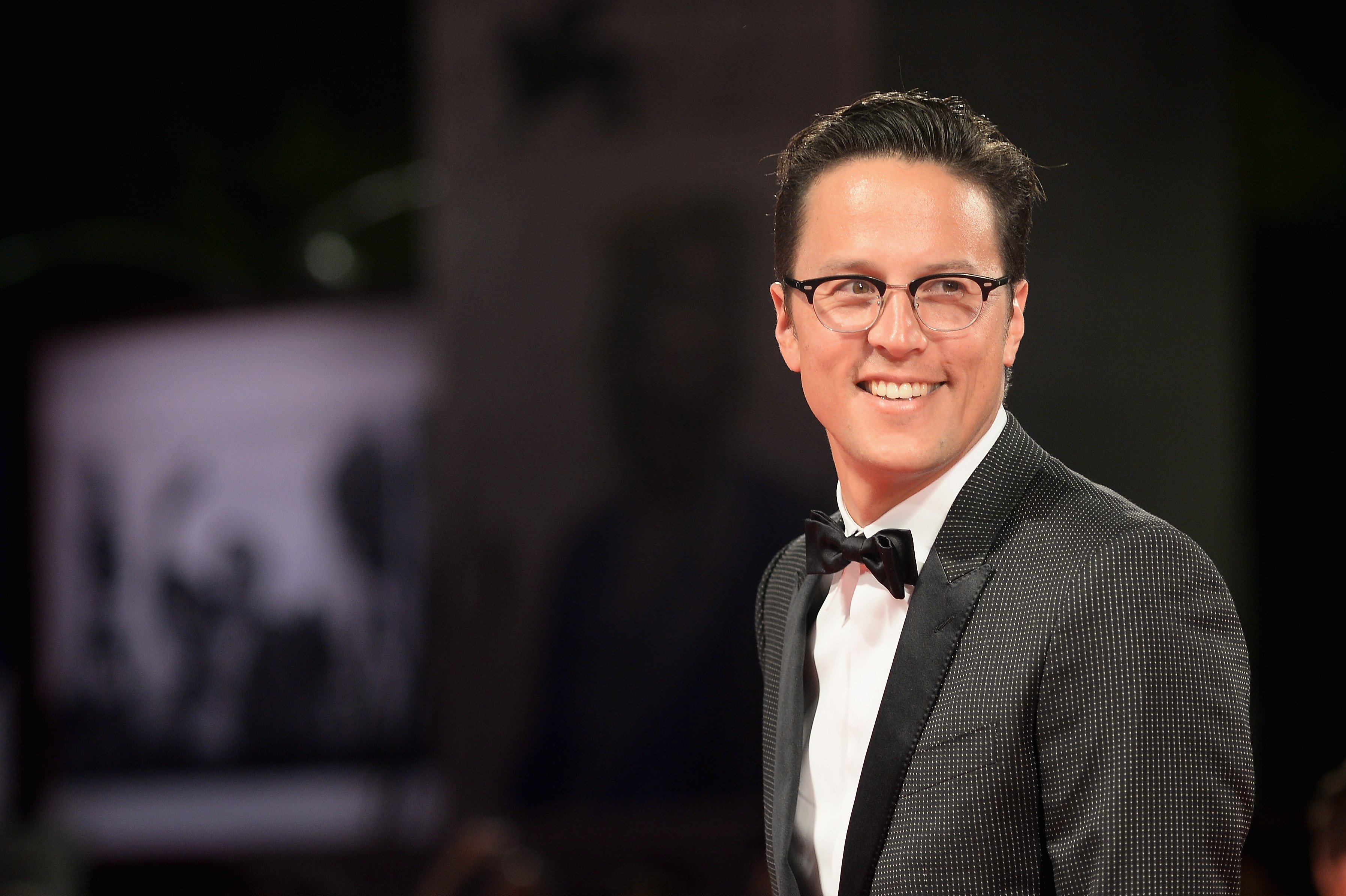 Cary Fukunga director of the new James Bond movie No Time to Die flashes a smile