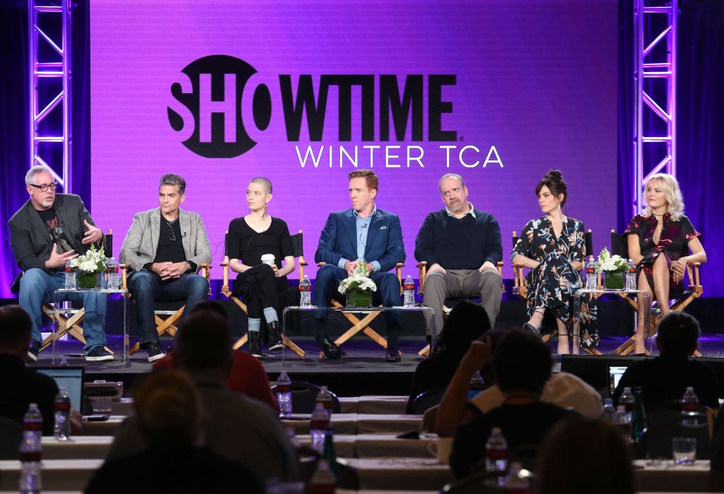 Cast of 'Billions' sits on stage during a panel.