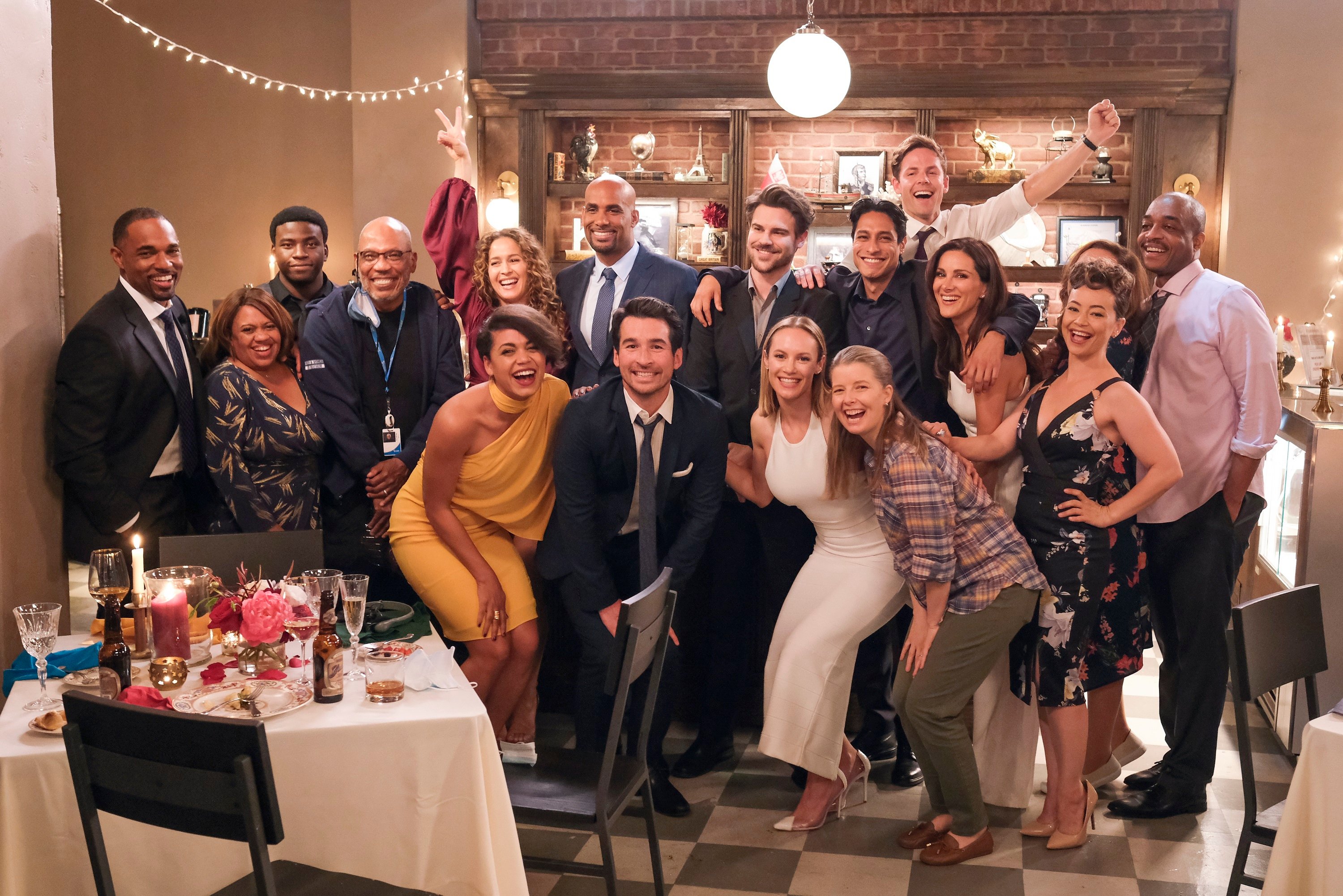 The cast of Station 19 poses for a group photo at Carina and Maya's wedding