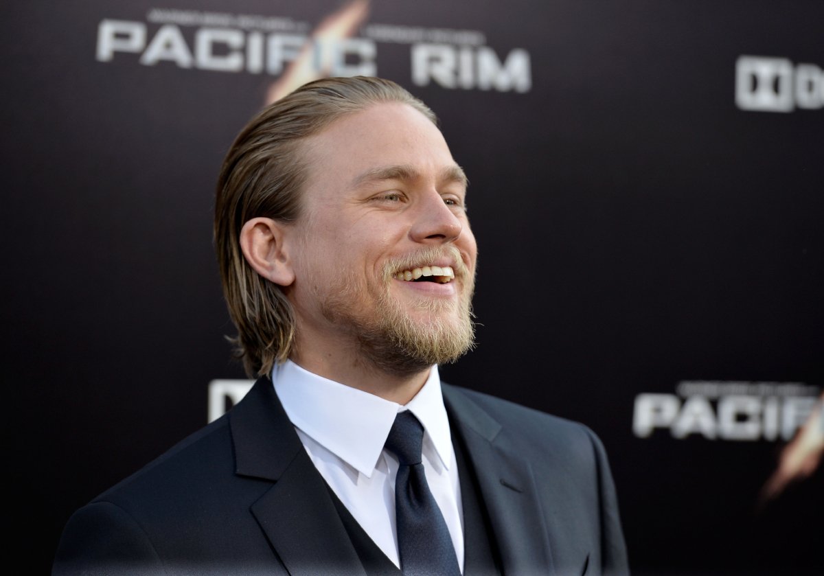 'Sons of Anarchy' star Charlie Hunnam from the chest up smiling and wearing a suit