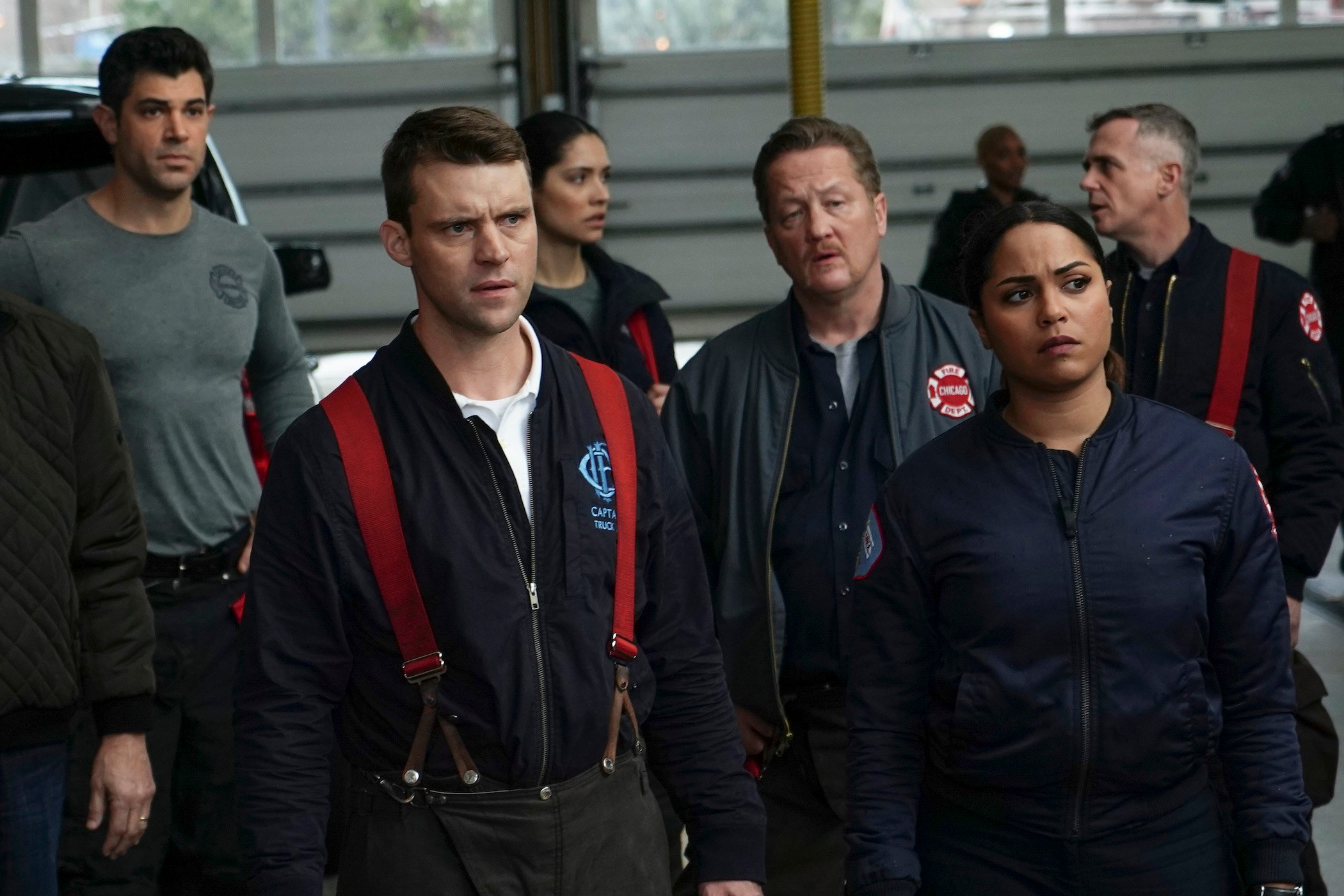 Matt Casey and Gabriela Dawson in 'Chicago Fire' standing in front of others in the firehouse. Matt Casey left 'Chicago Fire' Season 10