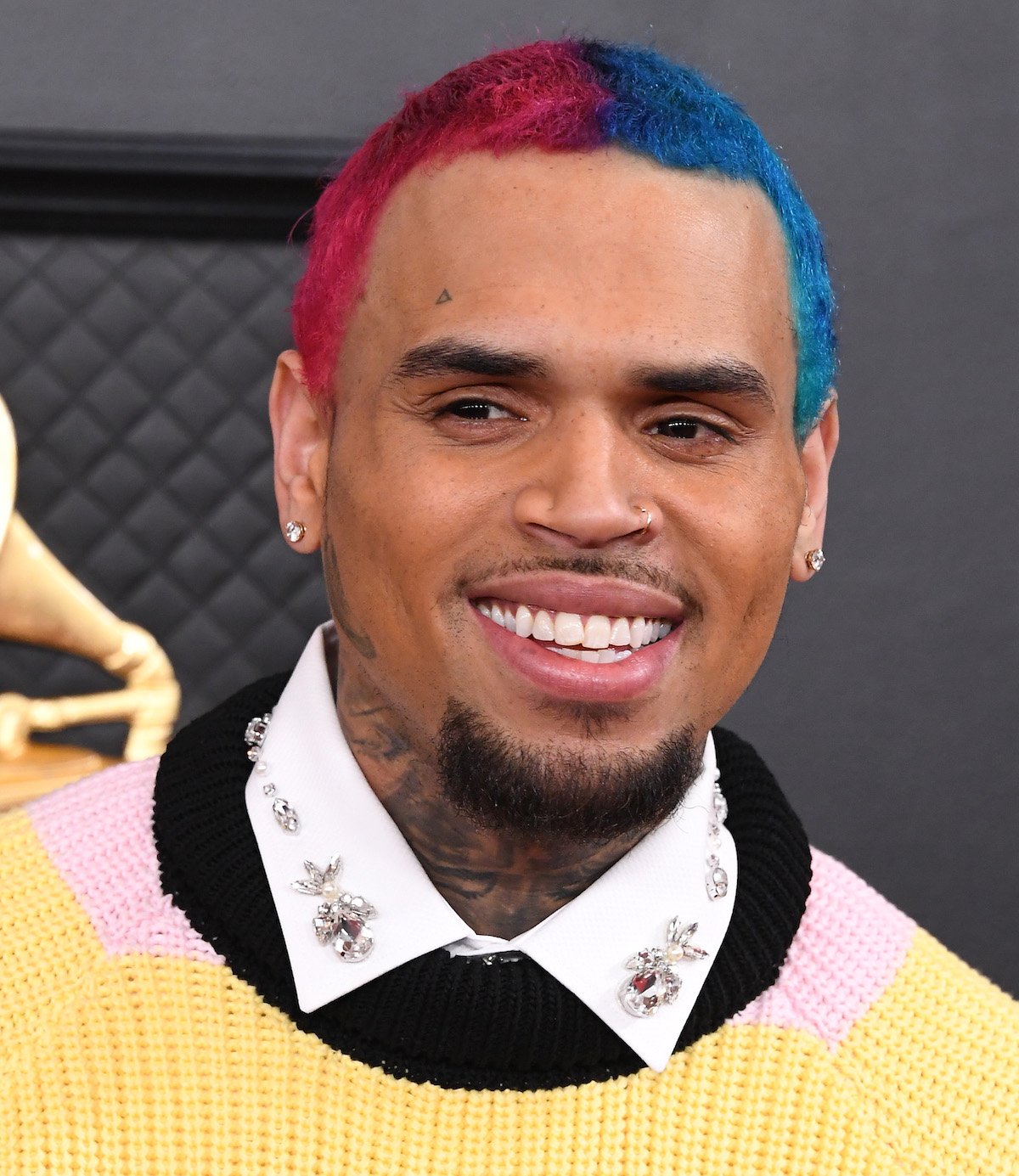 Chris Brown smiles for the camera at an event.
