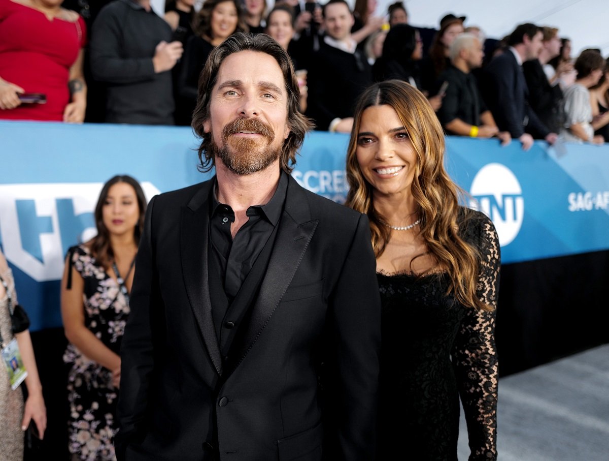 Christian Bale and his wife smiling