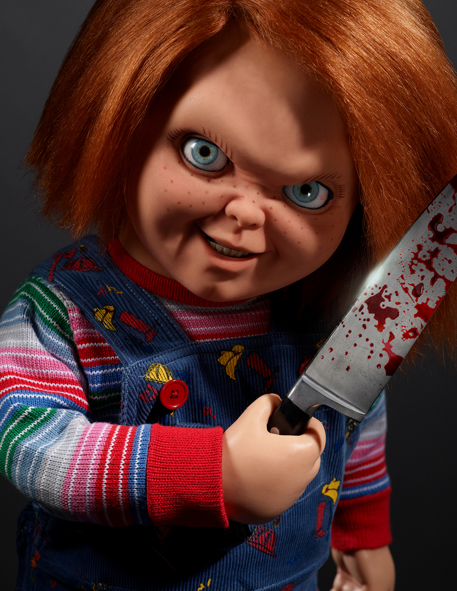Child's Play killer doll Chucky holds a bloody knife