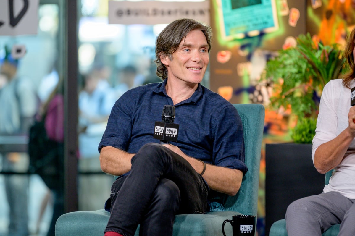 Cillian Murphy discusses "Peaky Blinders" with the Build Series. Murphy is wearing a blue button-down shirt and holding a microphone.