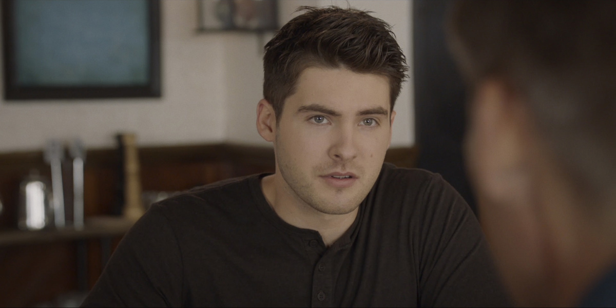 Cody Christian wearing a black shirt in 'All American.'