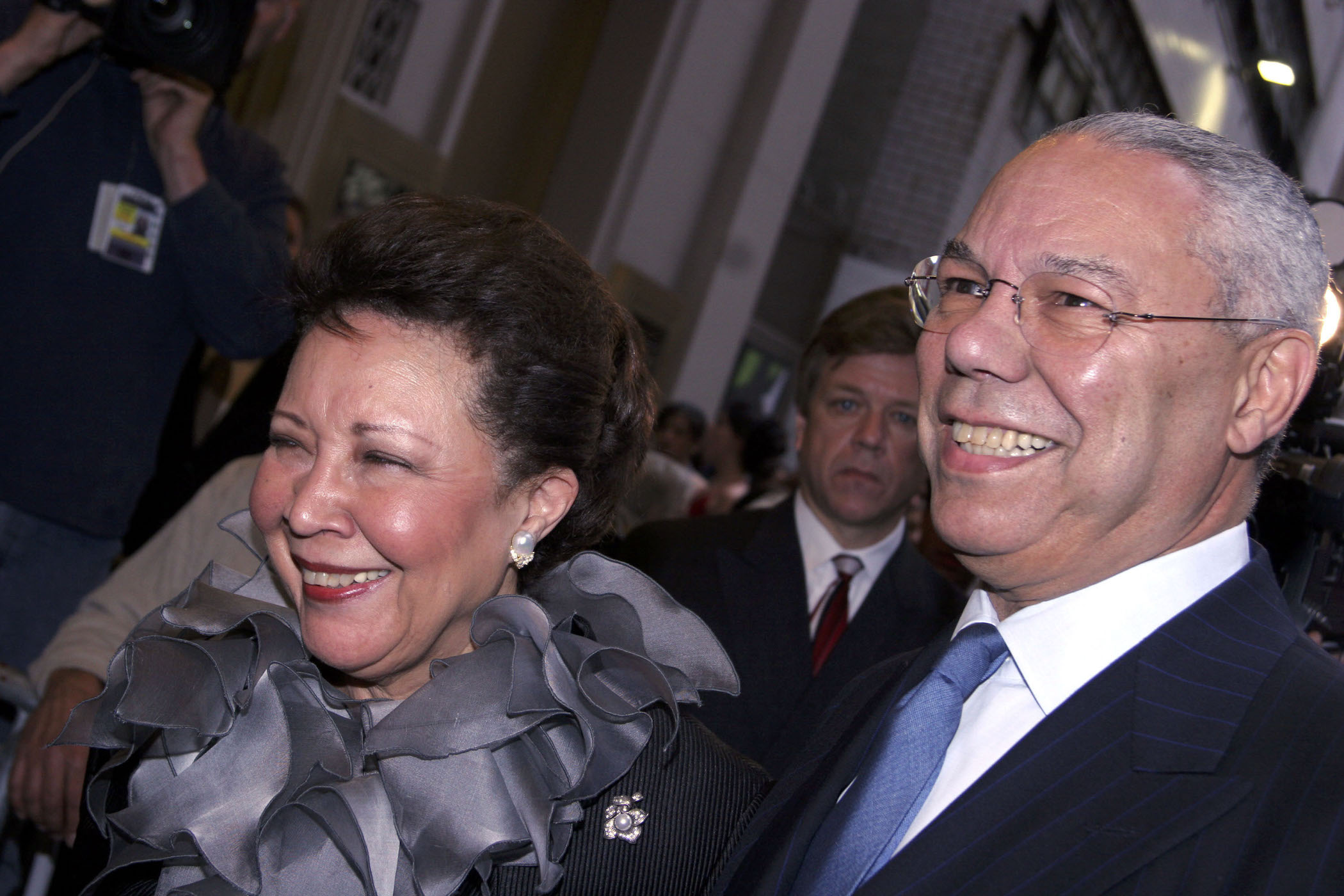 Colin Powell and Colin Powell's wife, Alma Powell, smiling together at an event