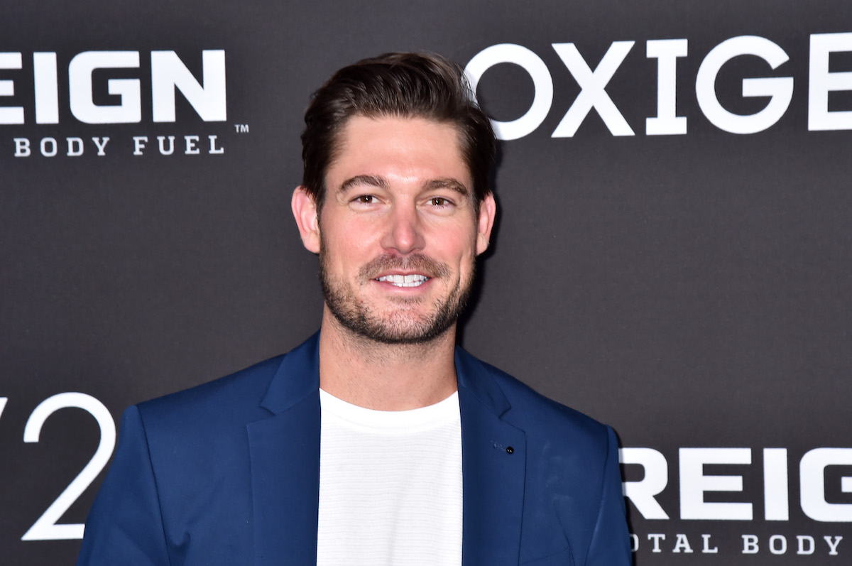 Craig Conover from "Southern Charm" smiles for the camera at an event.