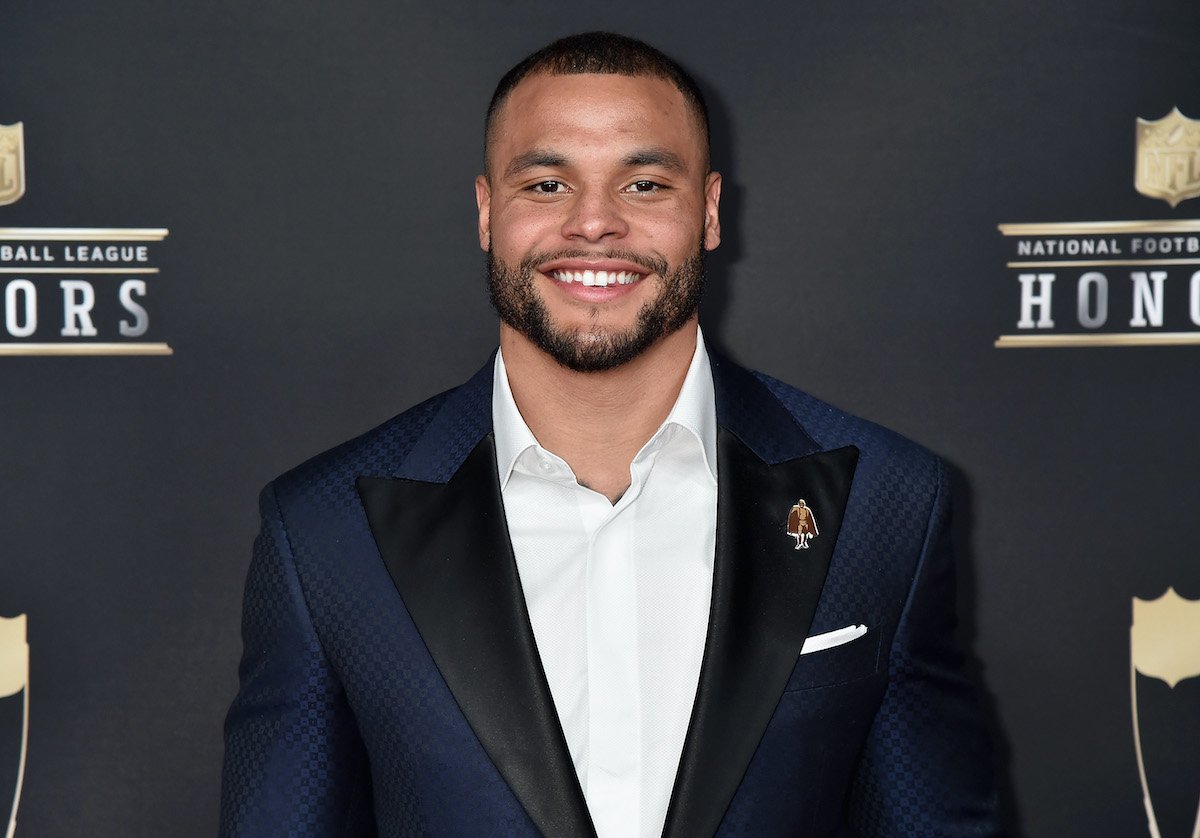 Dak Prescott smiling in front of a black background