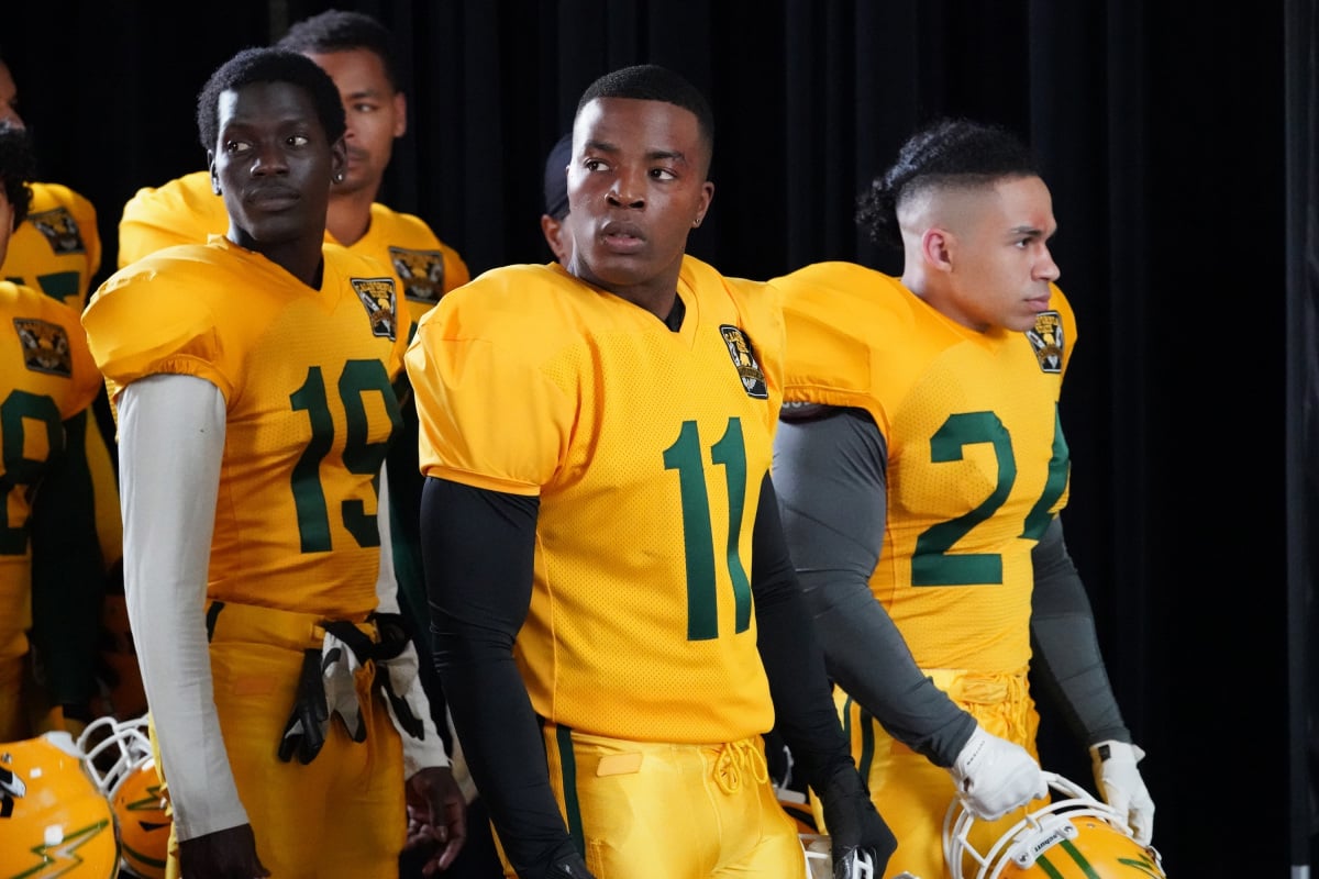 Daniel Ezra, and Noah Gray-Cabey wearing football uniforms in 'All American' Season 3.