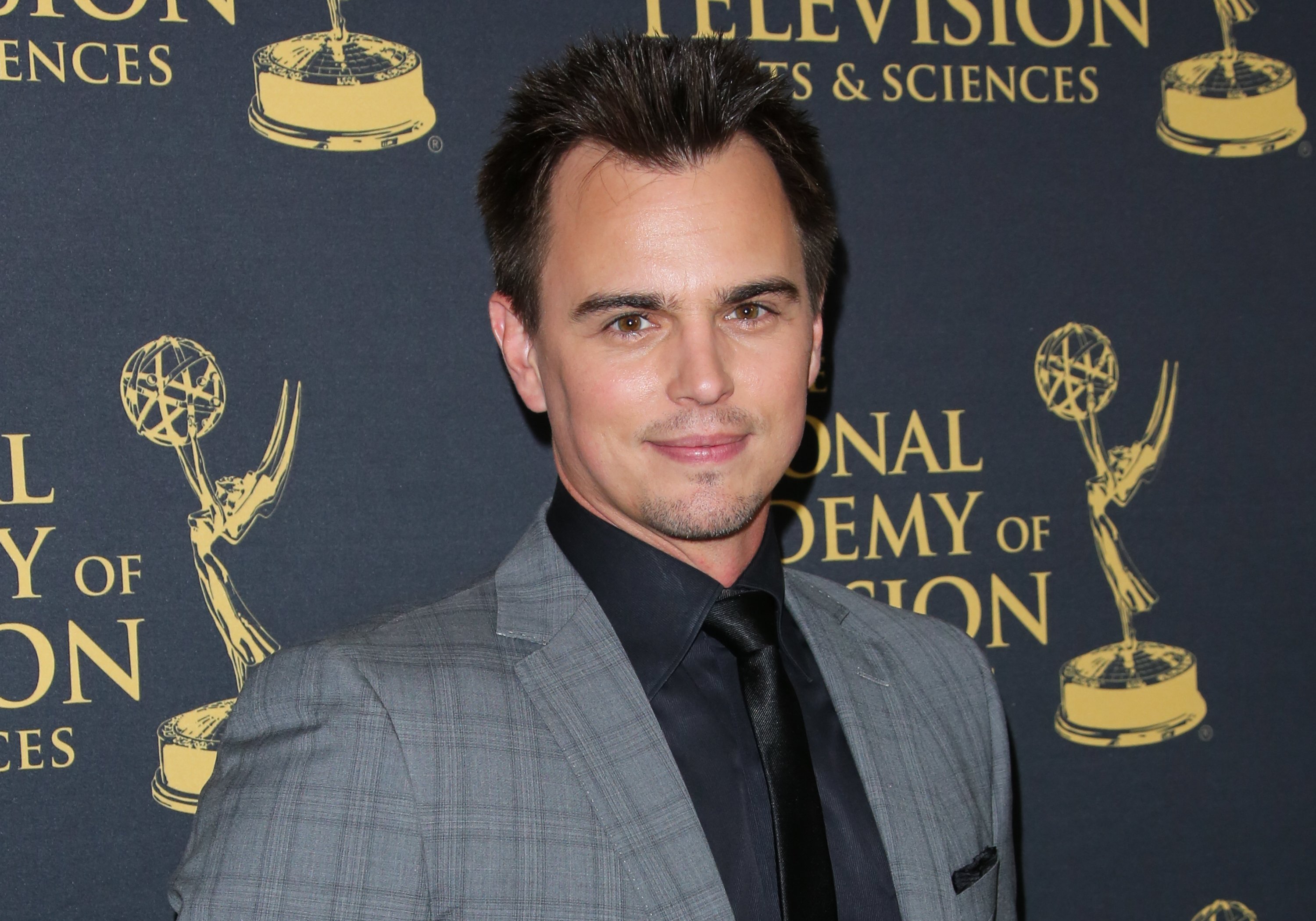 'The Bold and the Beautiful' actor Darin Brooks dressed in a grey suit, poses on the red carpet at the 2015 Daytime Creative Arts Emmys.