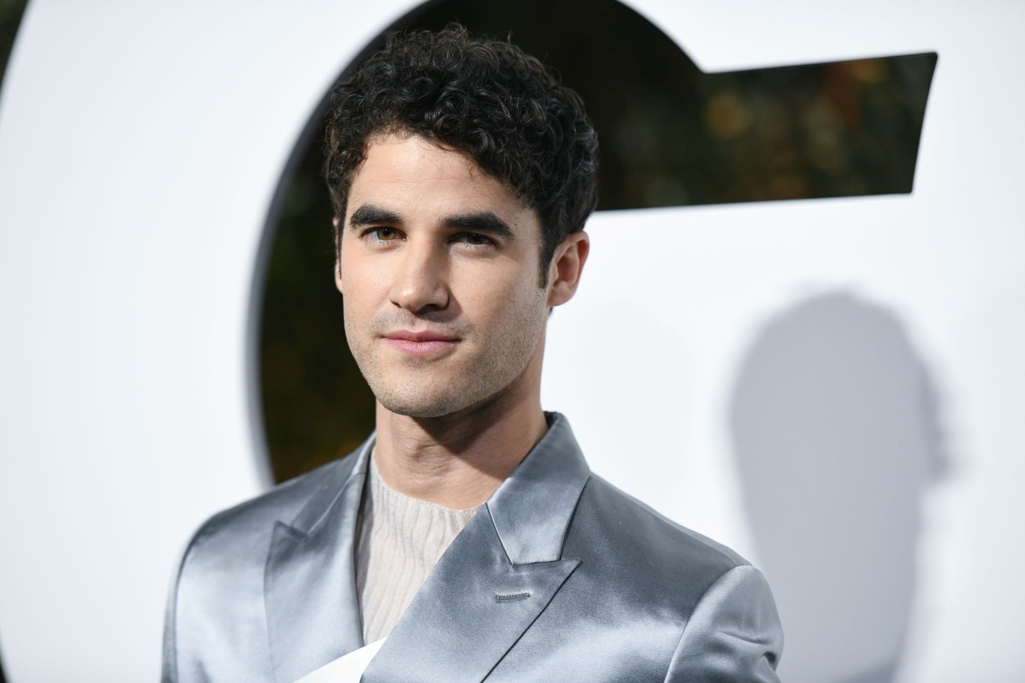 'Glee' actor Darren Criss wears a silver suit over a white shirt.