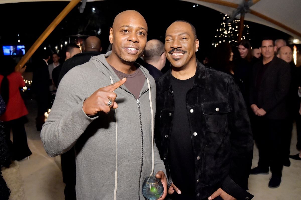 Dave Chappelle in grey and Eddie Murphy in black