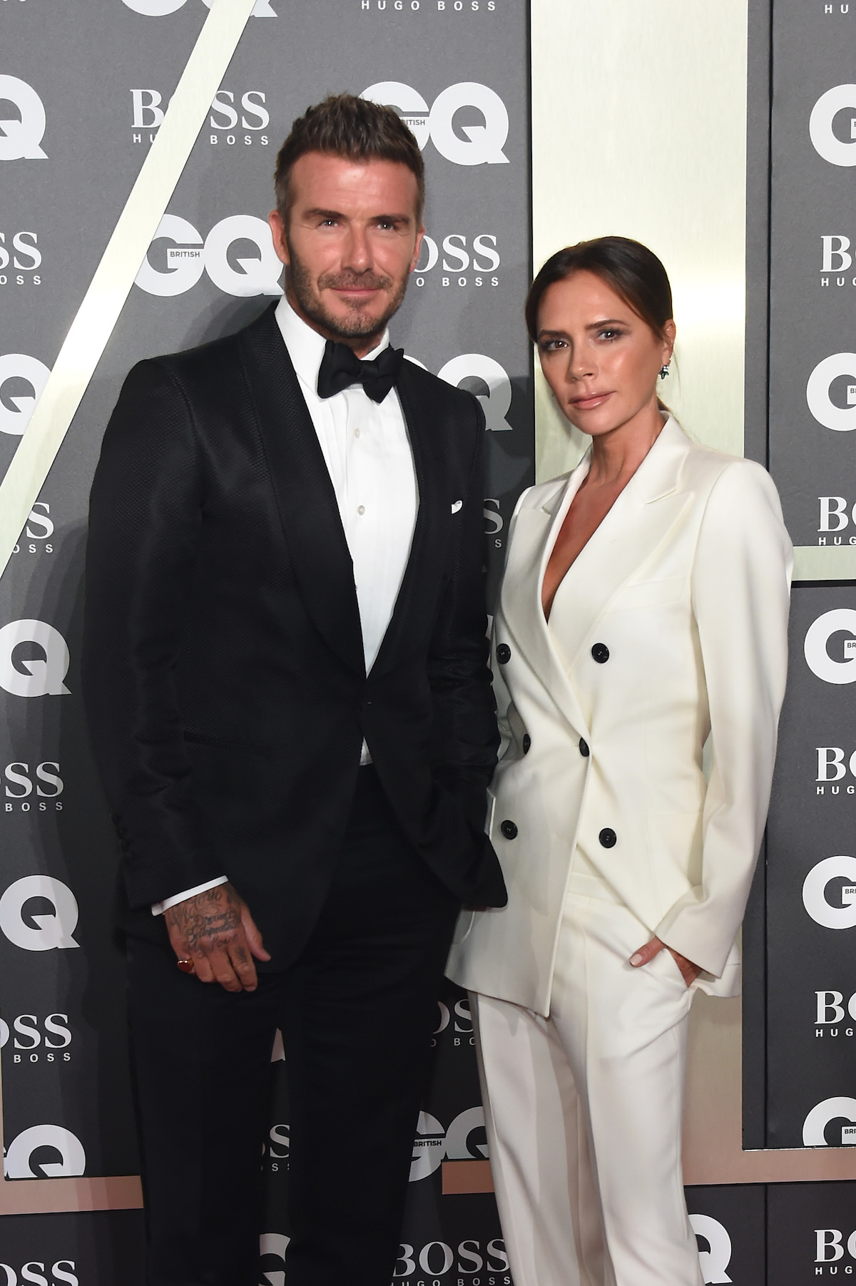 David Beckham and Victoria Beckham pose together at an event.