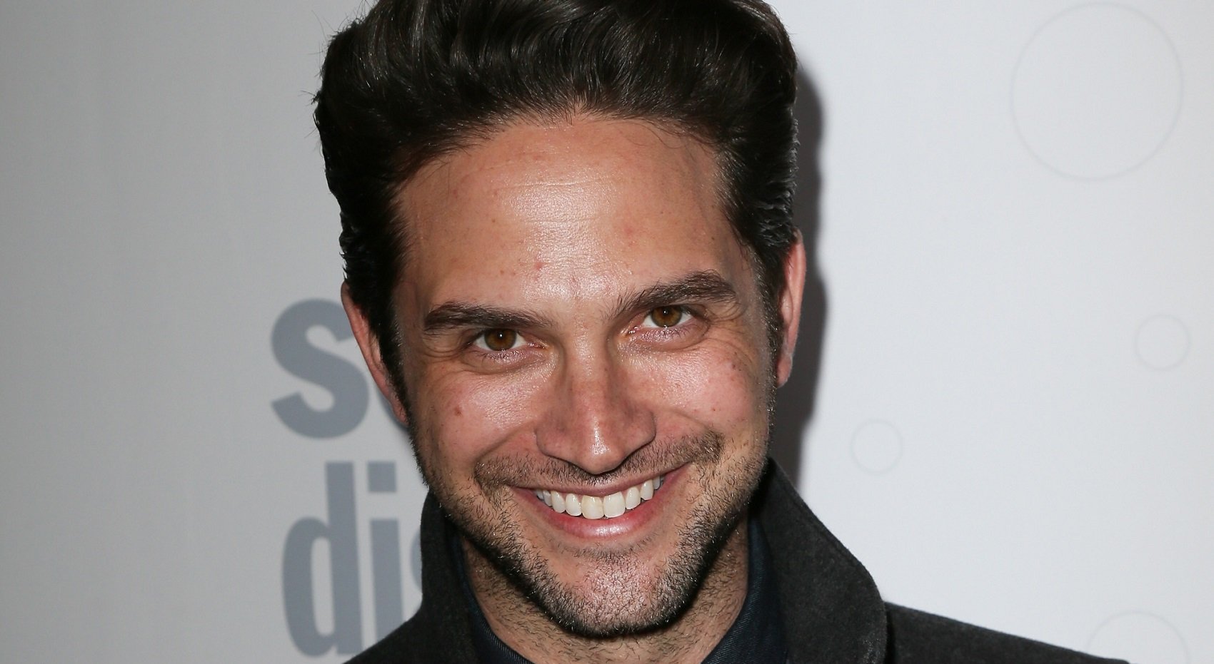 Days of Our Lives spoilers focus on Brandon Barash, pictured here against a soap opera digest background