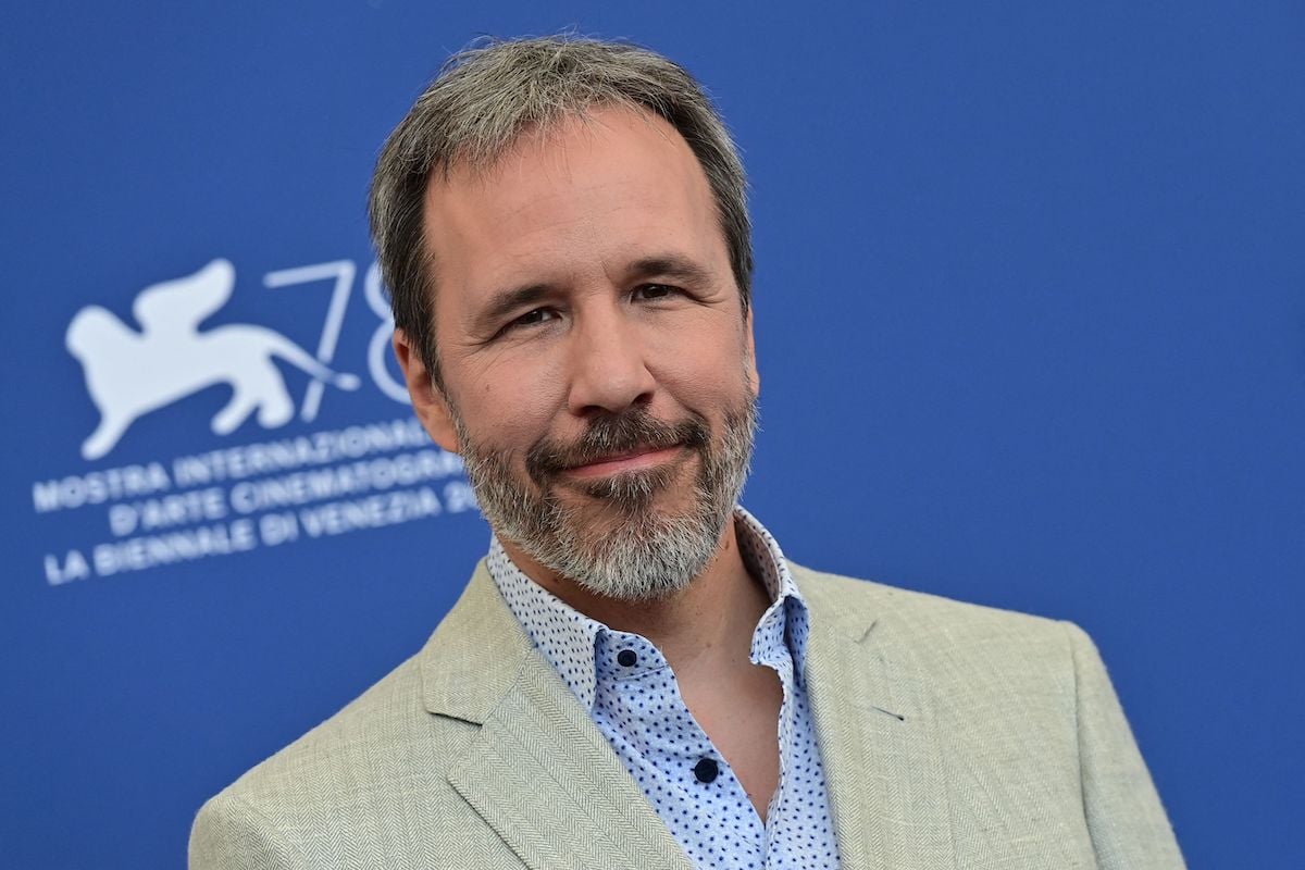 Denis Villeneuve, who wants to direct a James Bond movie, wearing a tan suit
