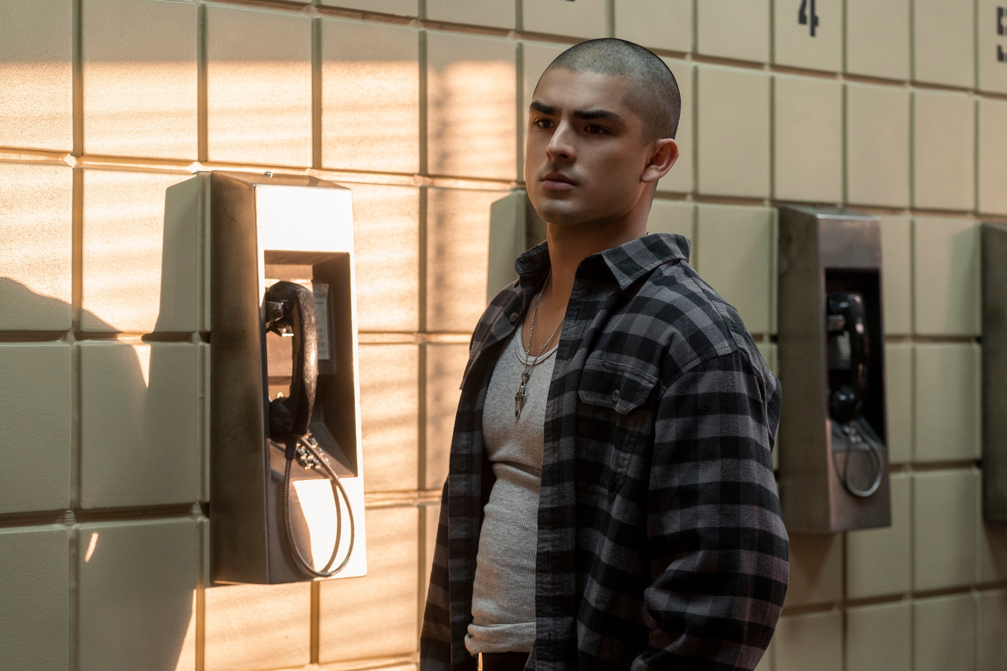 Diego Tinoco standing in front of a pay phone in 'On My Block' Season 4.