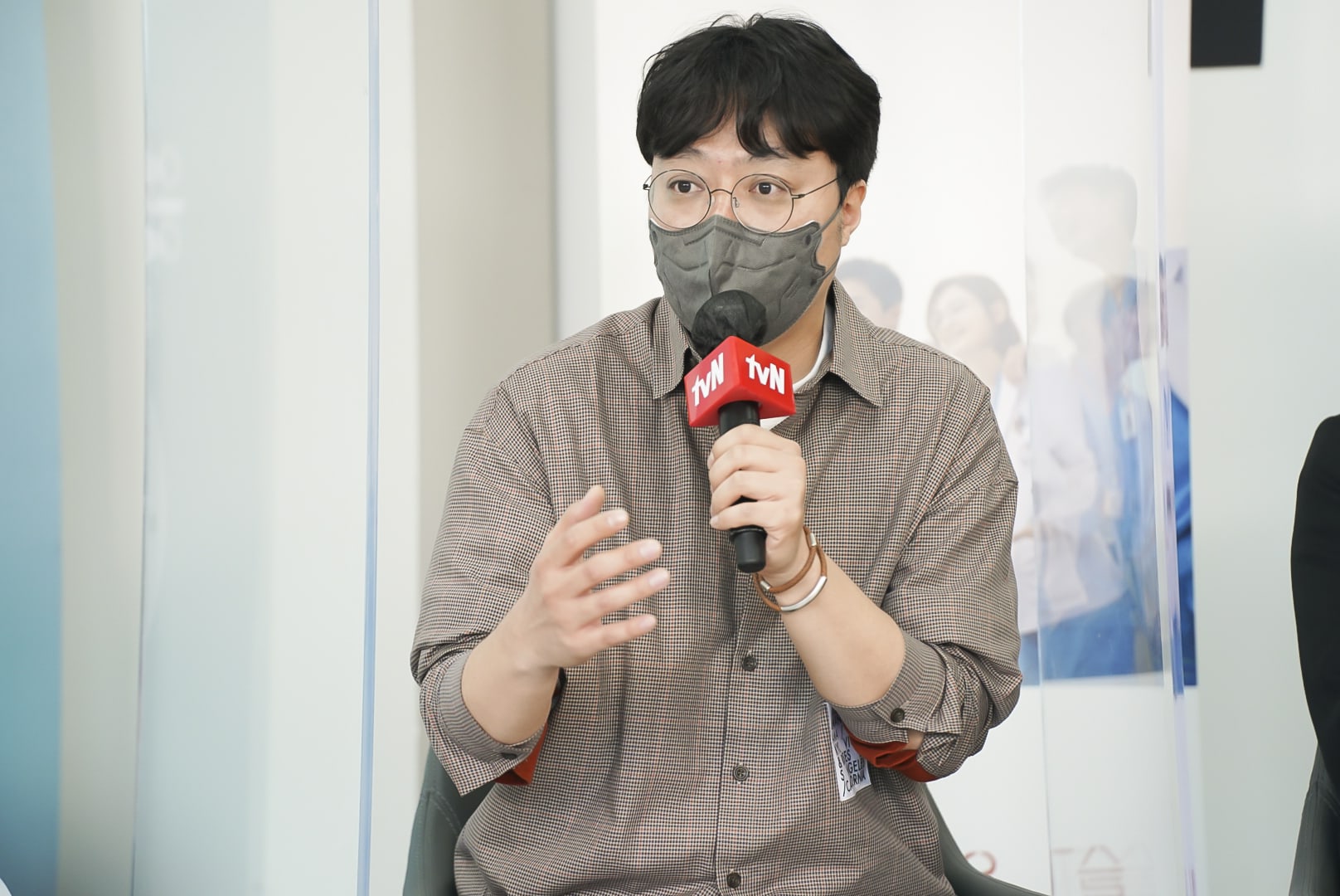 Director Shin Won-ho for 'Hospital Playlist' wearing face mask and holding microphone