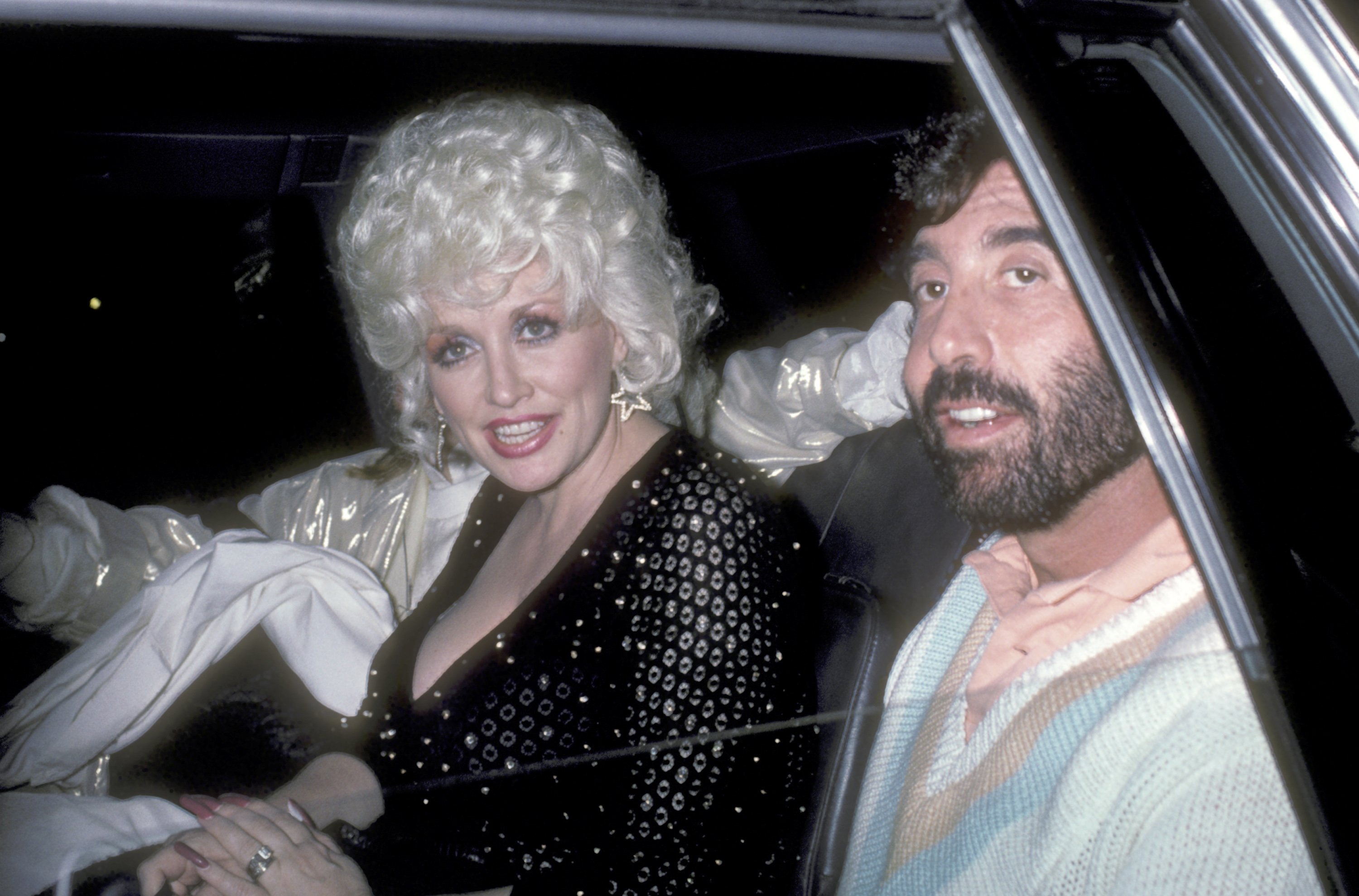 Dolly Parton in the car with her manager, Sandy Gallin, in 1985.