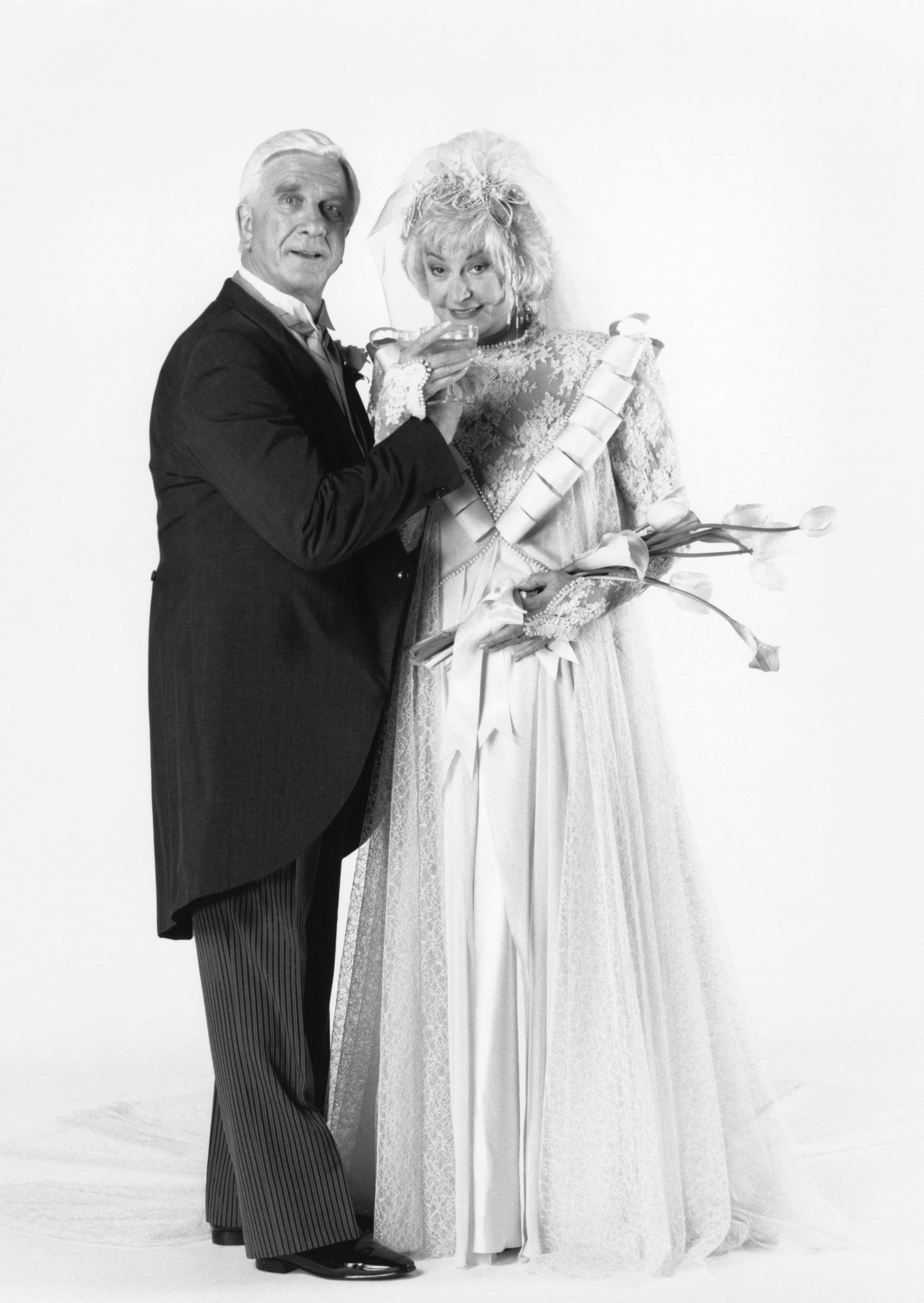 Leslie Nielson as Lucas Hollingsworth and Bea Arthur as Dorothy Zbornak pose for a wedding photo during the series finale of 'The Golden Girls'