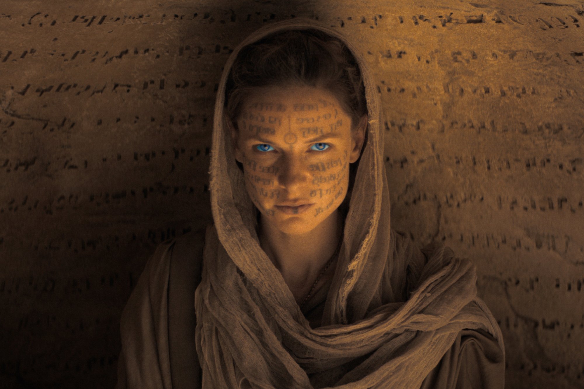 'Dune' actor Rebecca Ferguson as Lady Jessica with symbols on her skin and wearing a hood