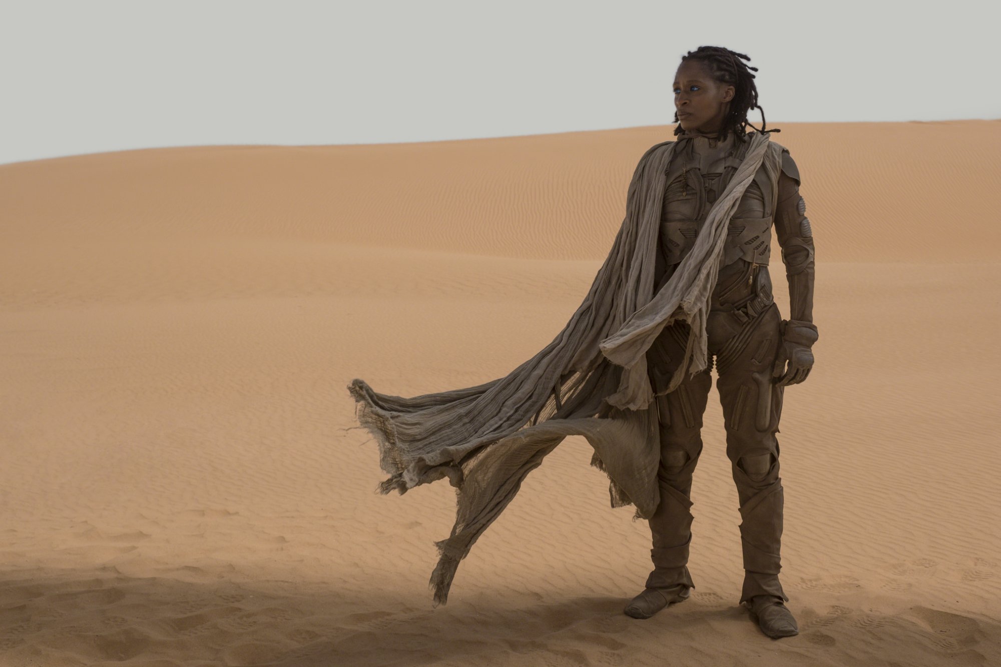 'Dune' actor Sharon Duncan-Brewster as Liet Kynes standing on the sand dune in suit