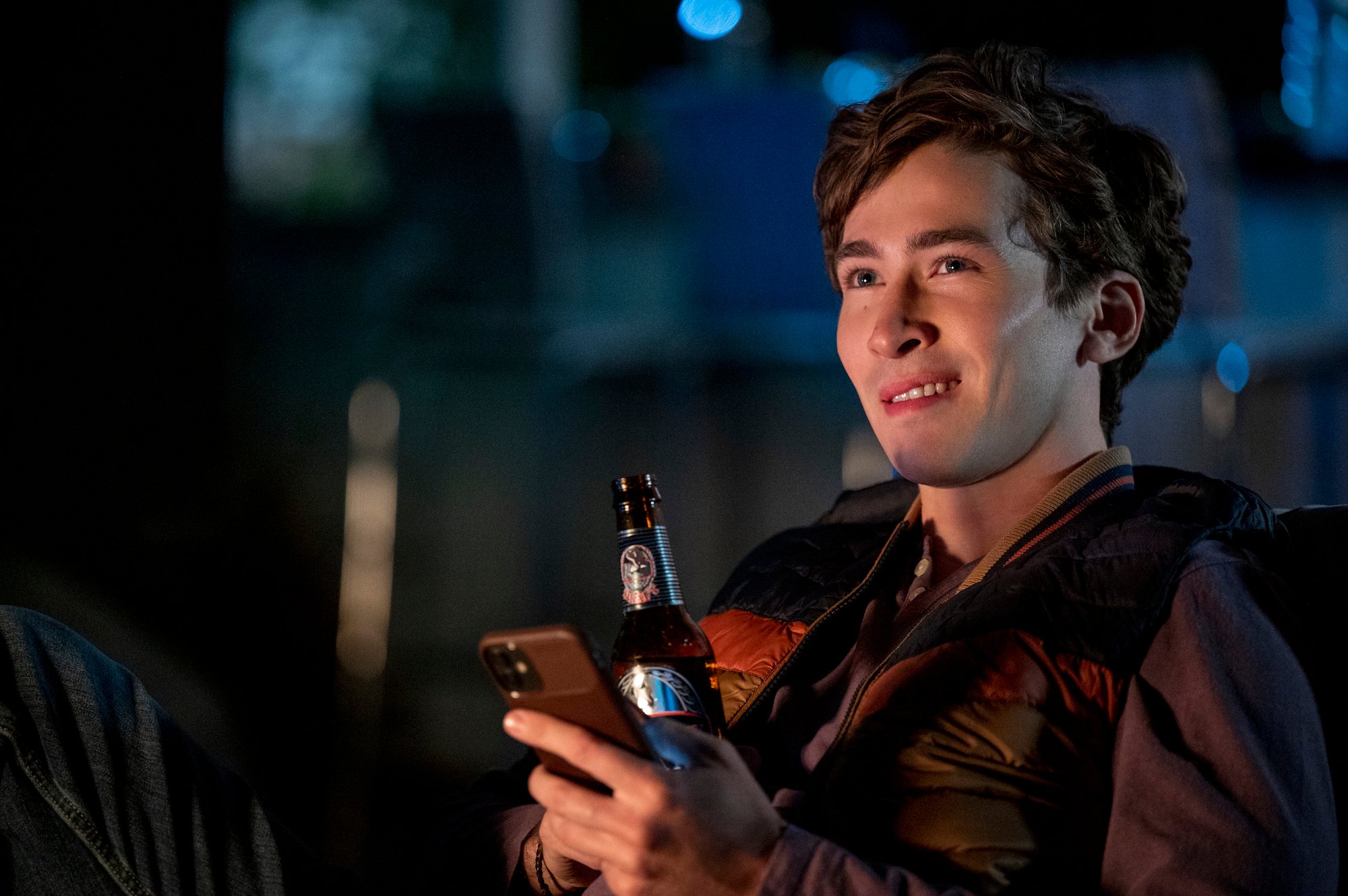 Dylan Arnold drinking a beer in 'You' Season 3.