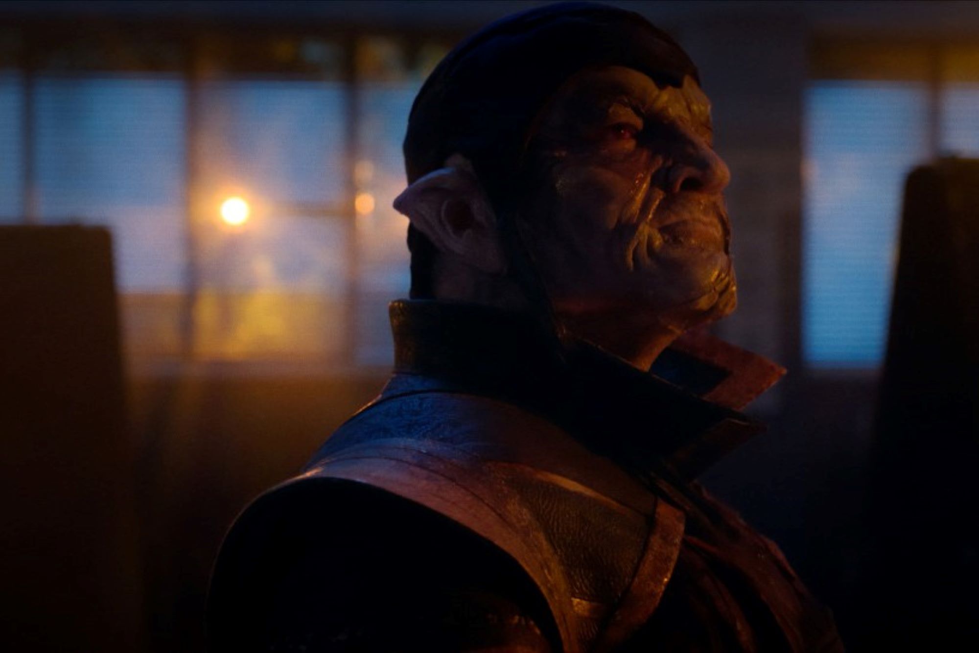 'Stargirl' actor Nick Tarabay, in character as Eclipso, wears gruesome face makeup, with pointy ears, and wears his Eclipso suit which has a gold vest and collar.