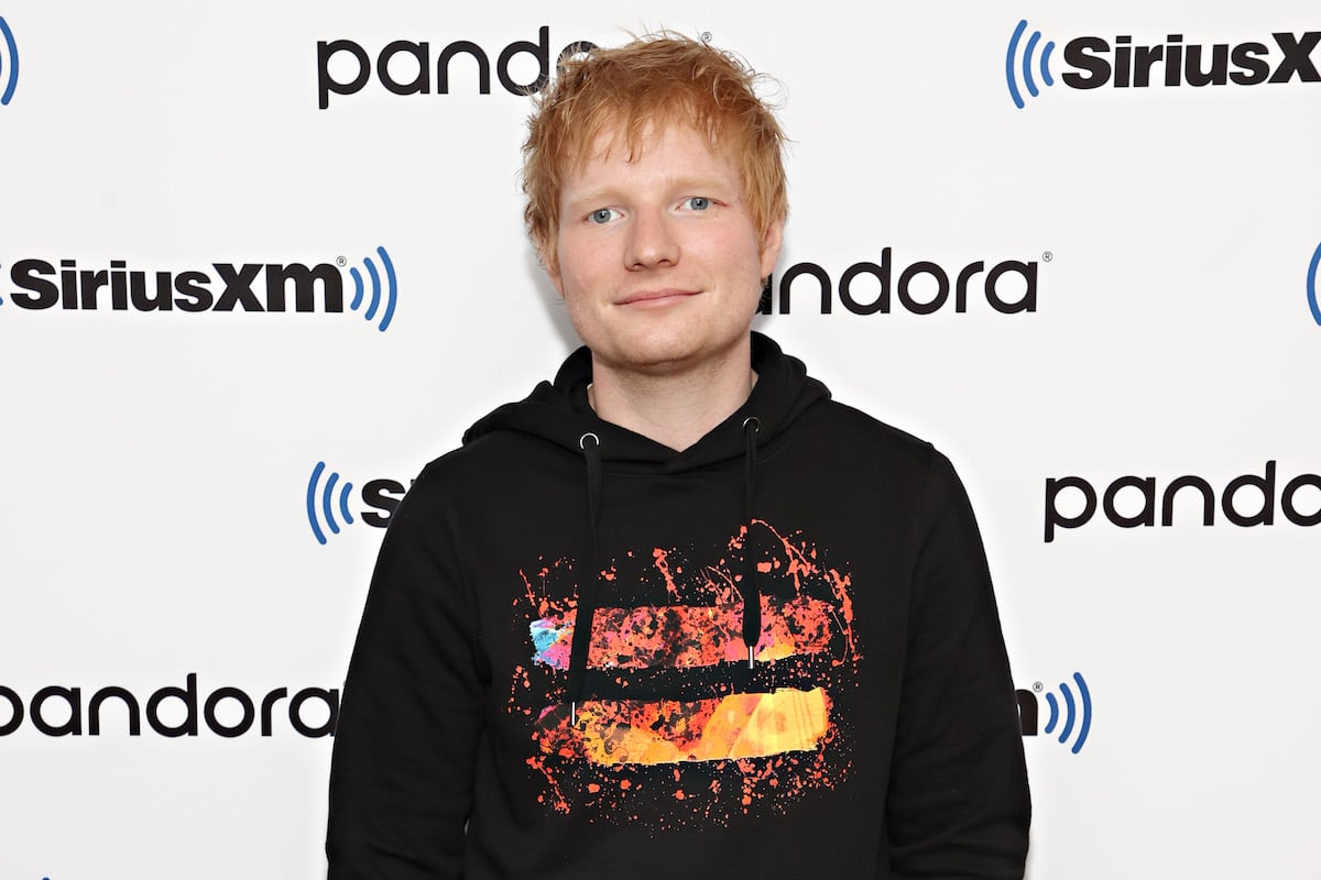 Ed Sheeran smiles for the camera at an event.