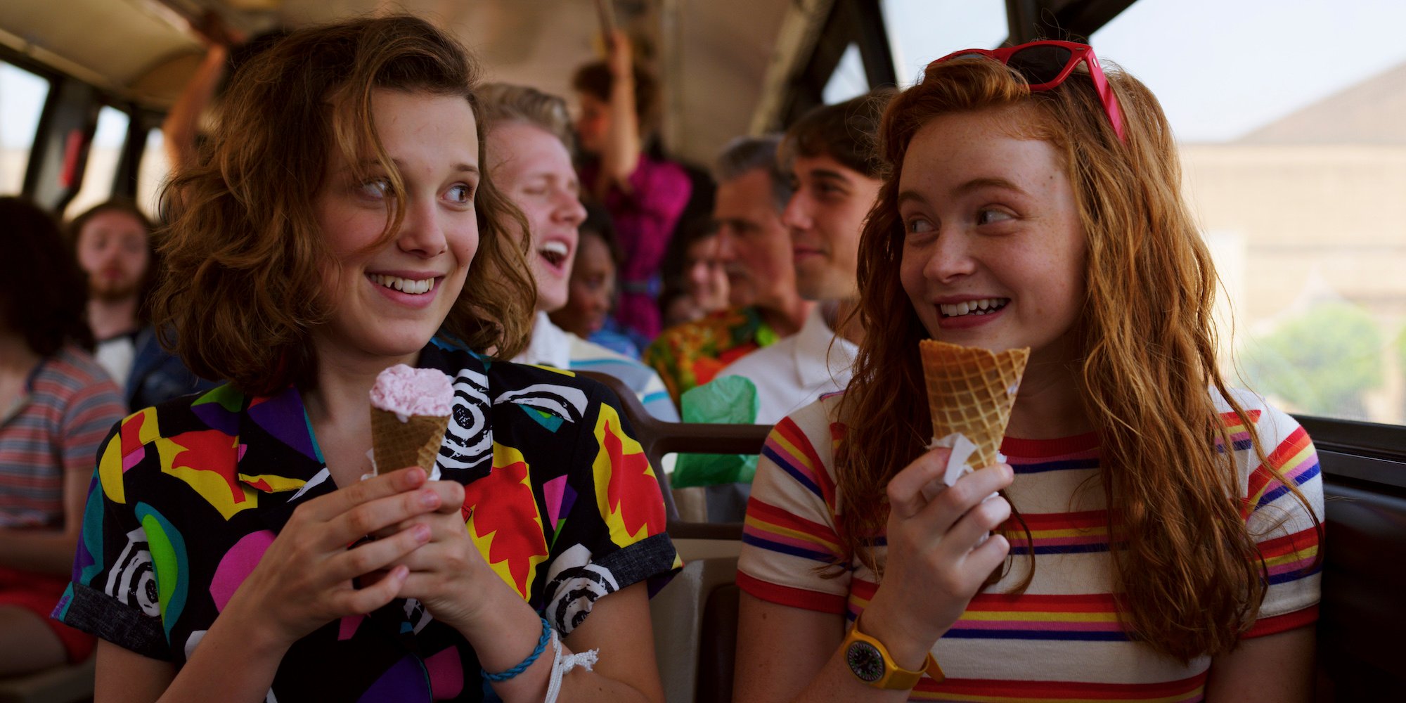 Eleven from 'Stranger Things' Season 3 in a bright colored and patterned shirt.