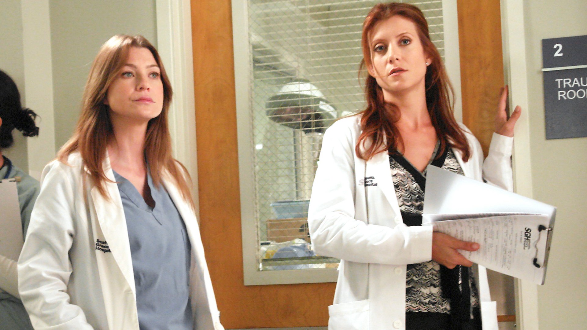 Ellen Pompeo as Meredith Grey and Kate Walsh as Addison Montgomery stand together in Seattle Grace Hospital in ‘Grey’s Anatomy’