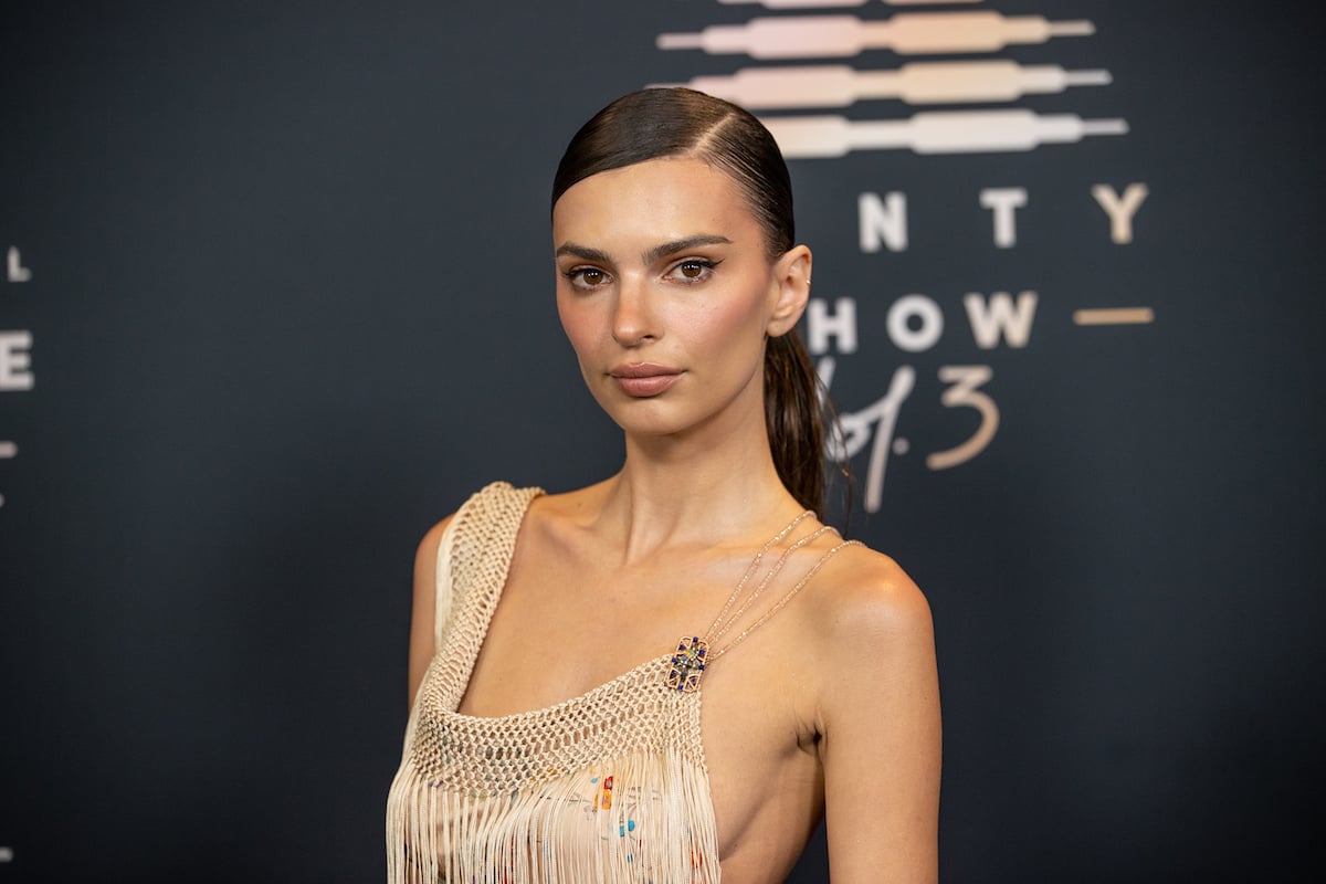 Emily Ratajkowski faces the camera, unsmiling, at an event.