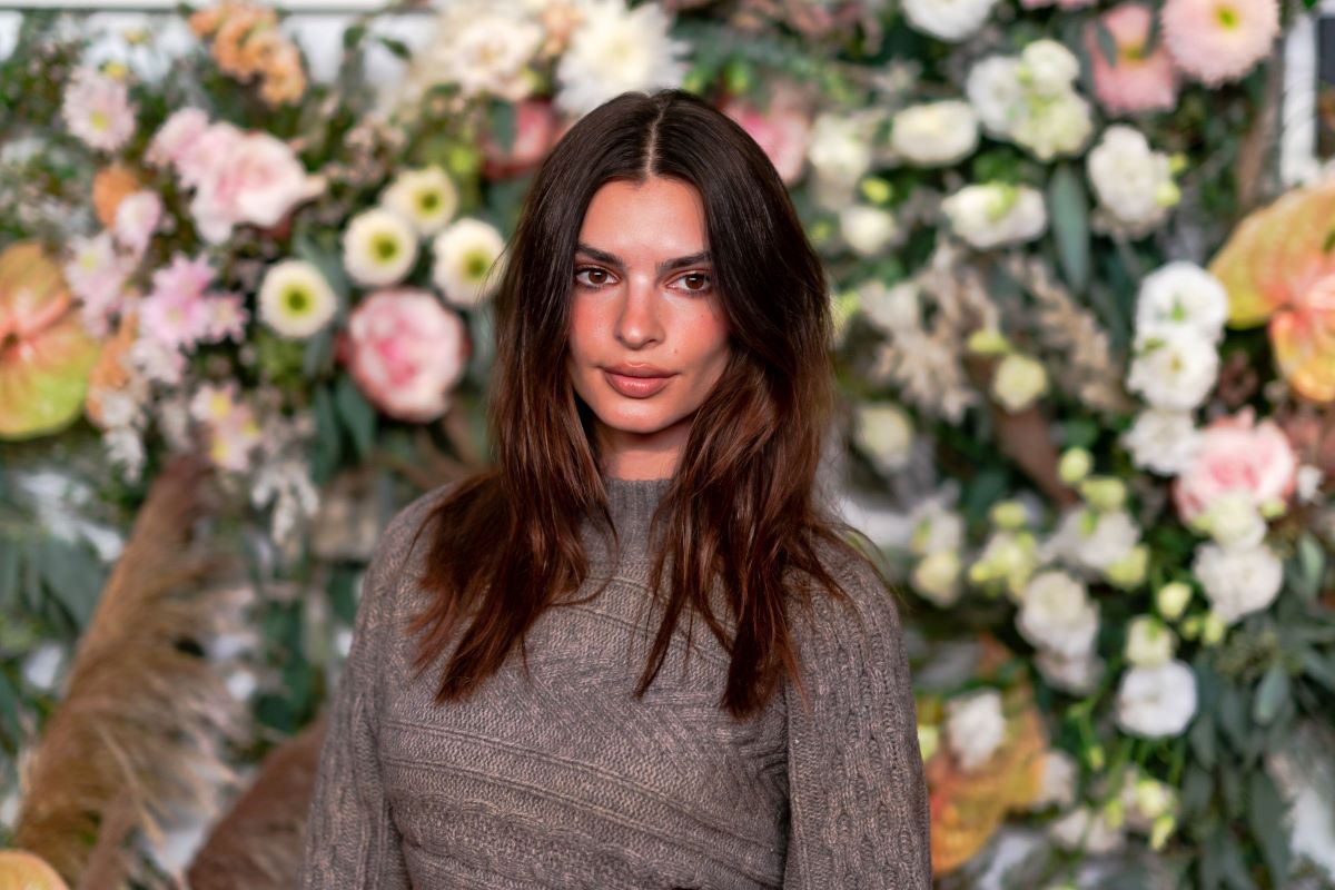 Emily Ratajkowski in sweater with floral background