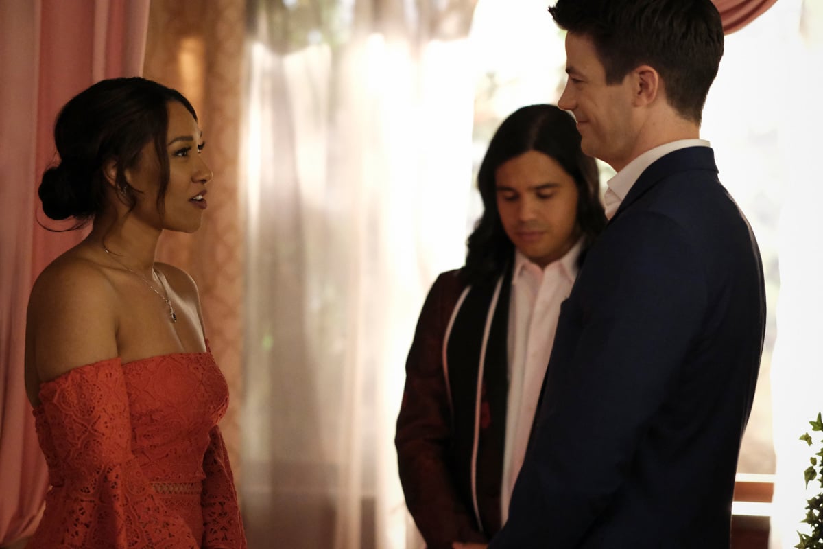 'The Flash' Season 7 actors Candice Patton, Carlos Valdes, and Grant Gustin, in character as Iris, Cisco, and Barry. Cisco officiates the vow renewal of Barry and Iris.
