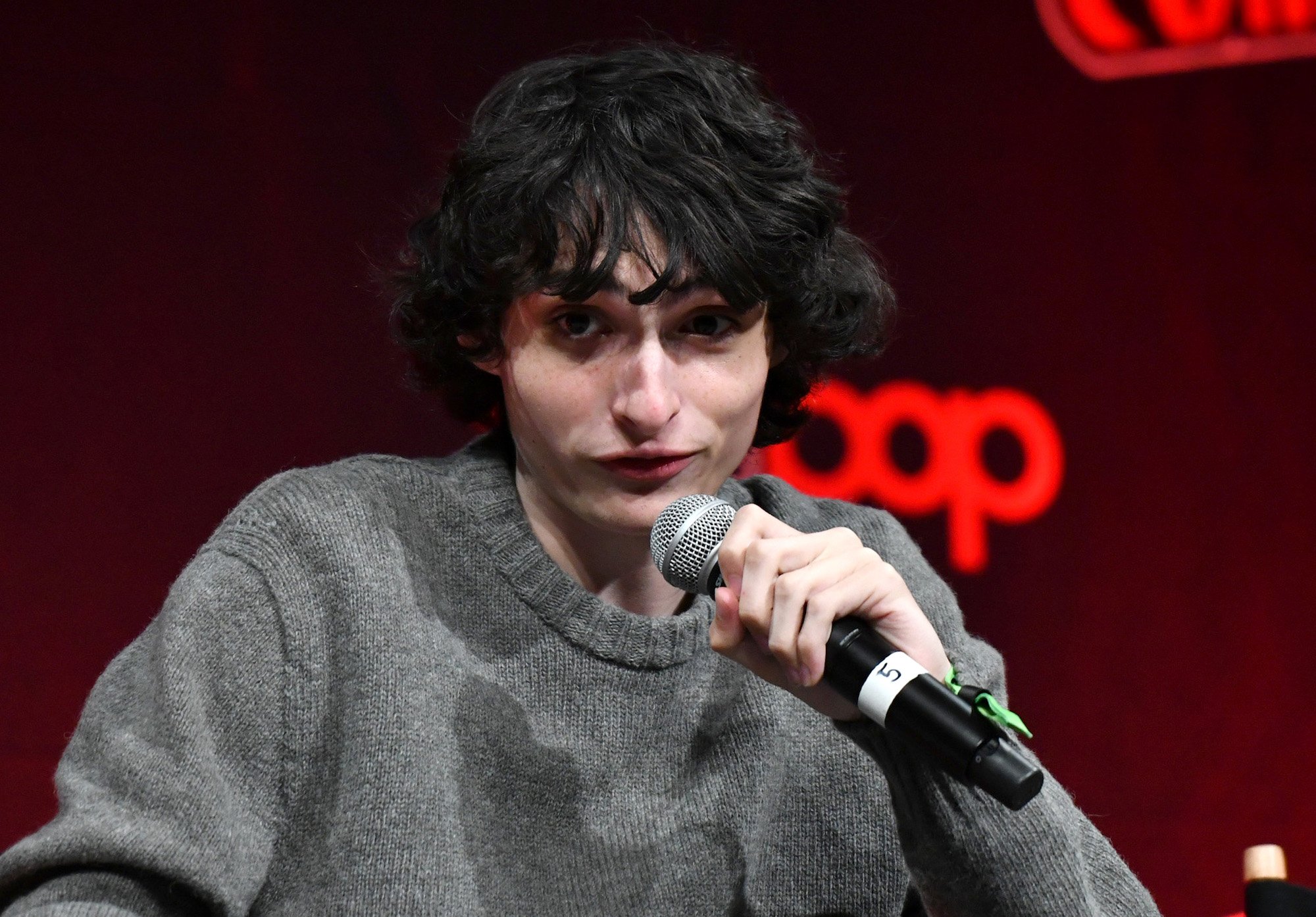 Finn Wolfhard, who stars in 'Stranger Things' Season 4, in a gray sweater at New York's Comic Con