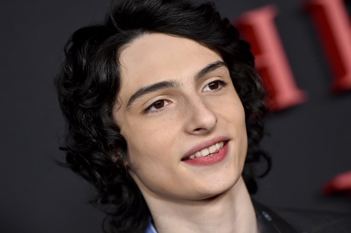 Finn Wolfhard of 'Ghostbusters: Afterlife' with dark background
