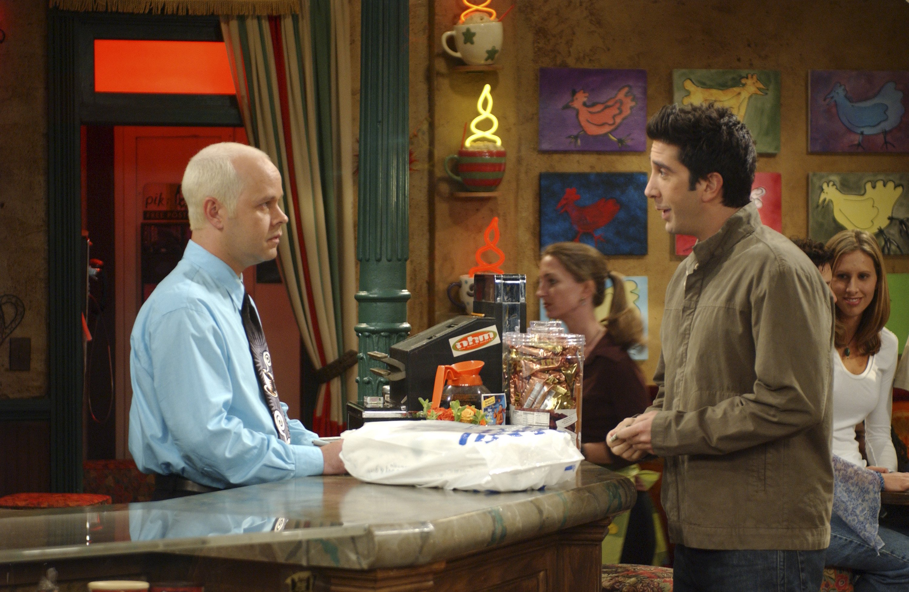 Ross (David Schwimmer) talks with Gunther (James Michael Tyler) at the coffee shop in Friends.