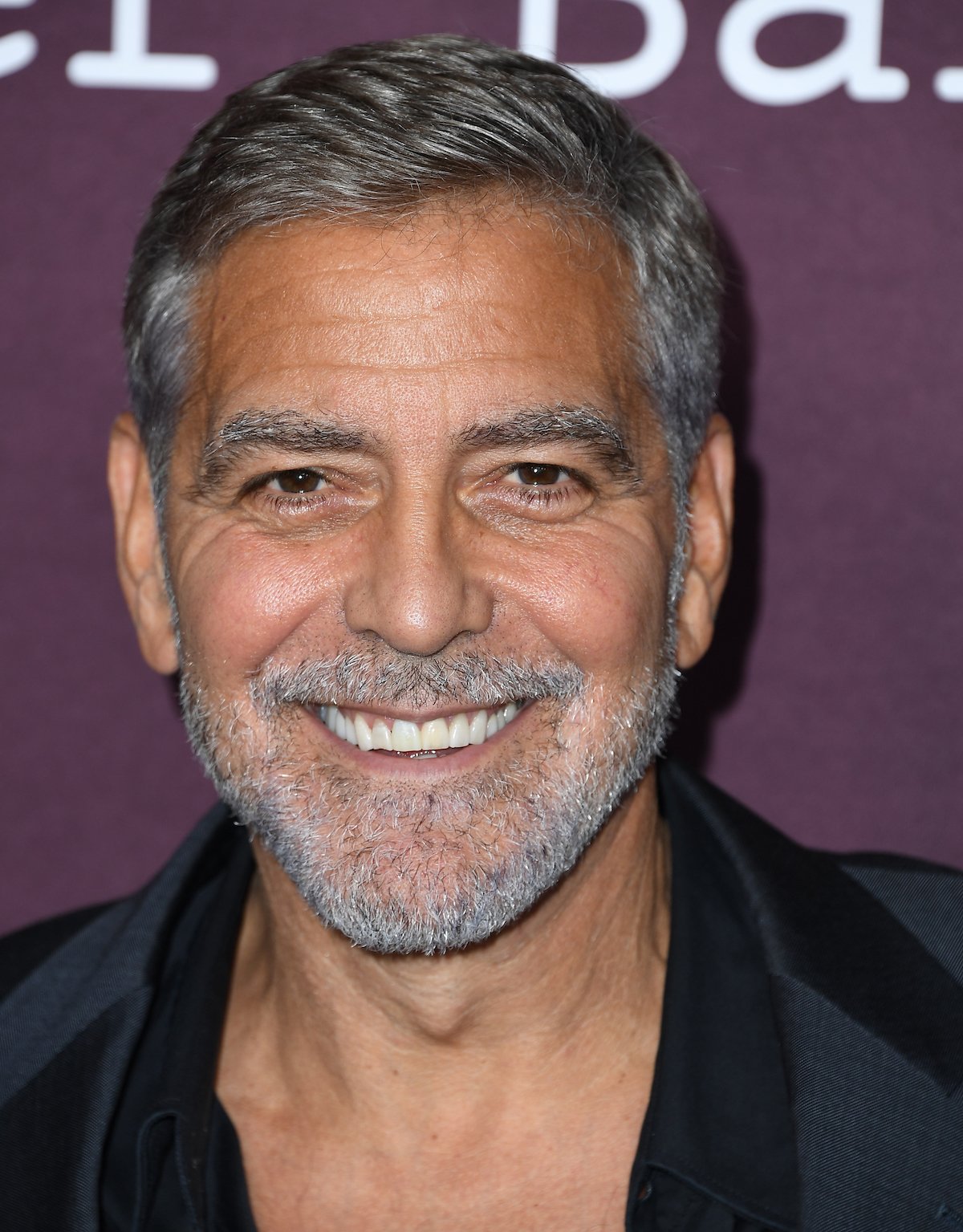 Close-up of George Clooney's face smiling for the camera.