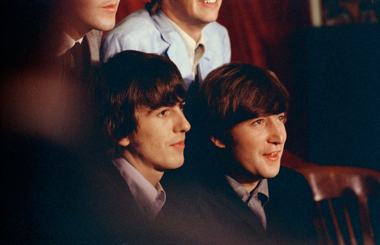George Harrison and John Lennon speaking at a press conference, 1965.
