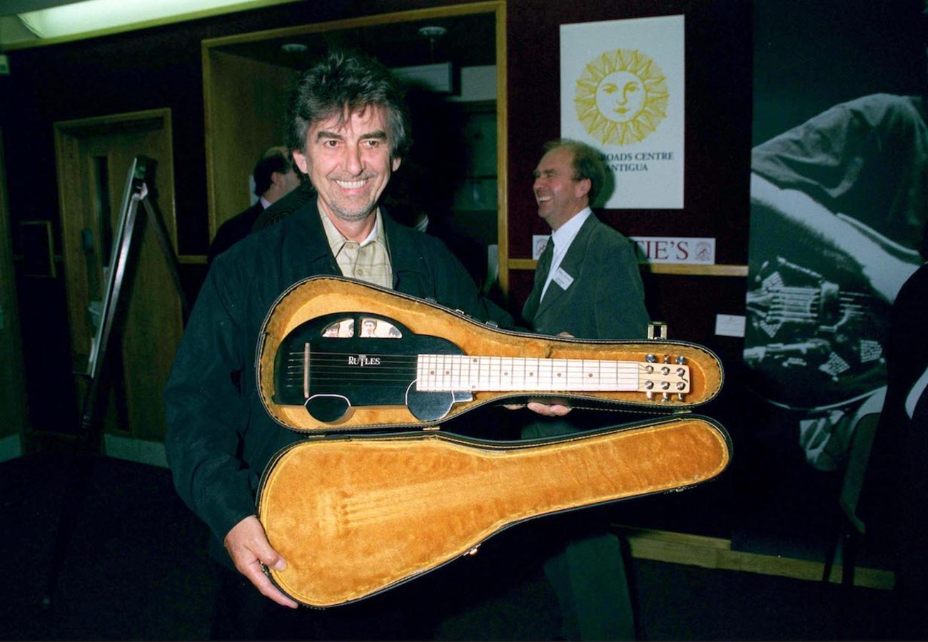 George Harrison at Christie's in London holding a ukulele, 1999.