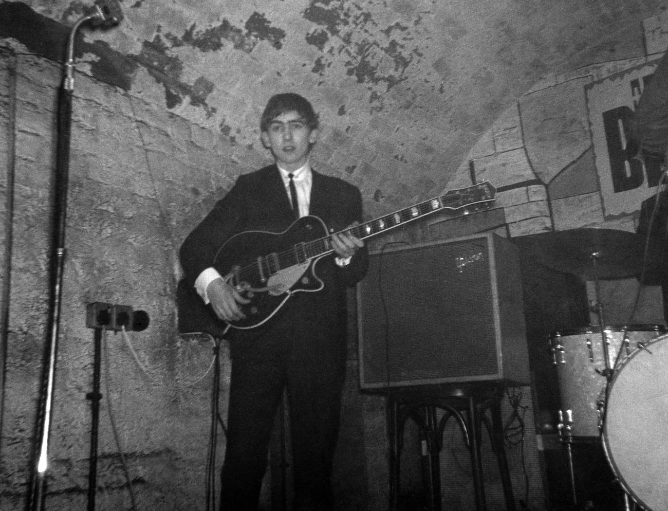 George Harrison playing his Gretsch guitar on stage with The Beatles, 1962.