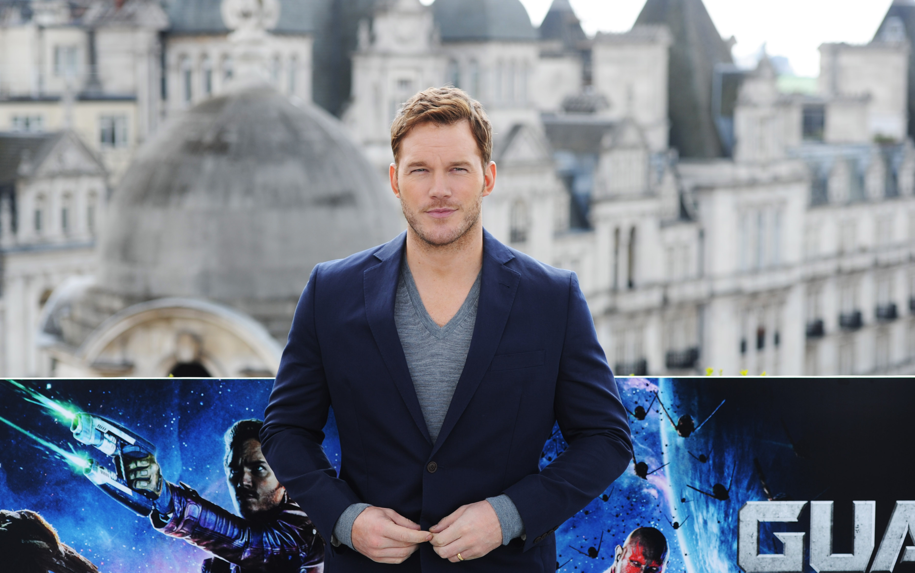 Chris Pratt, who plays Peter Quill in 'Guardians of the Galaxy,' posing in front of a movie poster