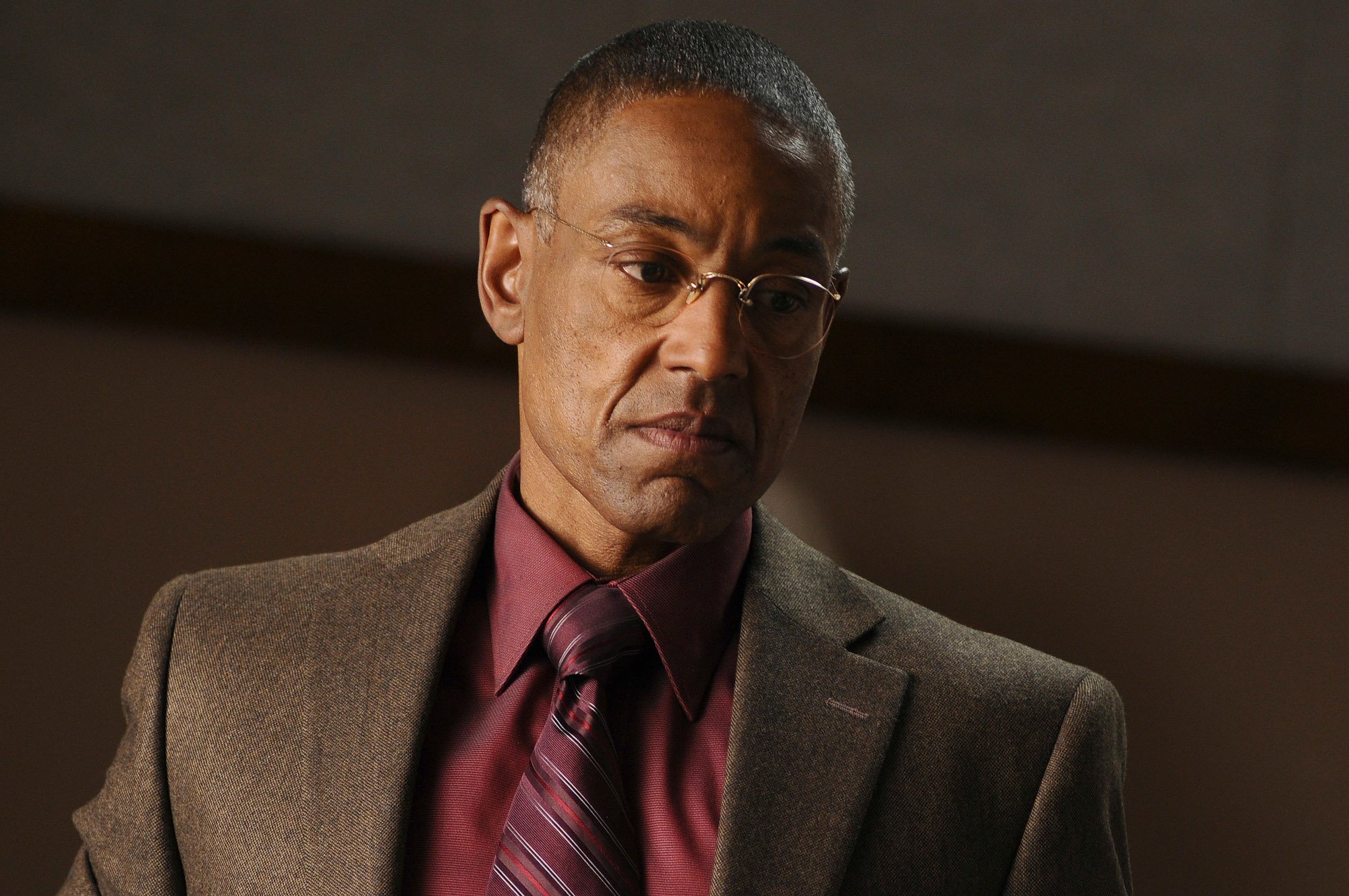 Giancarlo Esposito as Gus Fring in 'Breaking Bad' Season 4. He's wearing a suit and looks displeased.