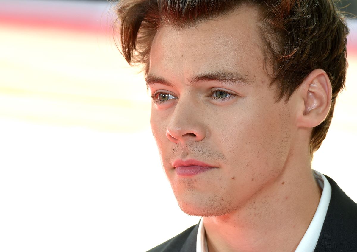 Harry Styles looking away from the camera on the red carpet of  the 'Dunkirk' premiere