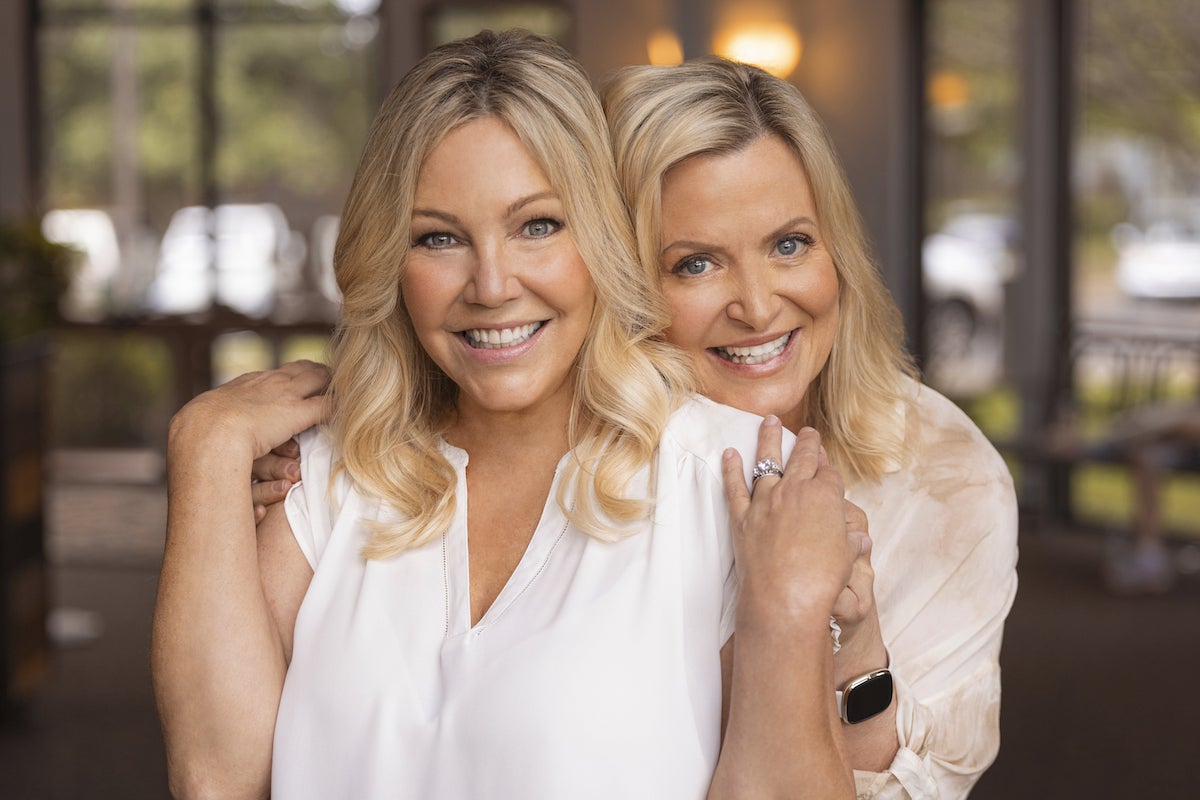 Kristine Carlson with her hands on the shoulders of Heather Locklear