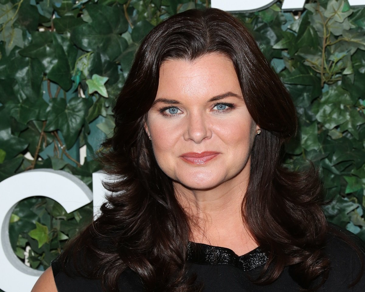 'The Bold and the Beautiful' actor Heather Tom in a black dress posing on the red carpet.