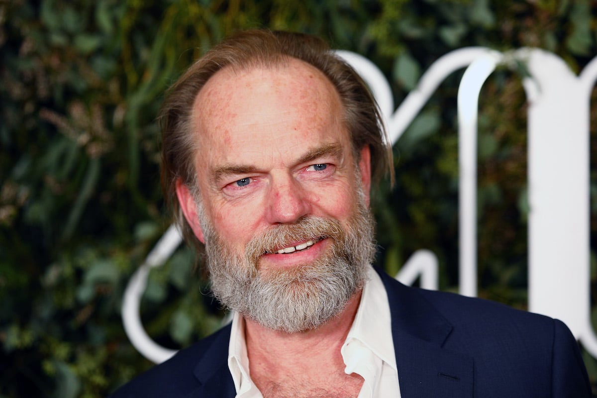 Hugo Weaving in front of a green background