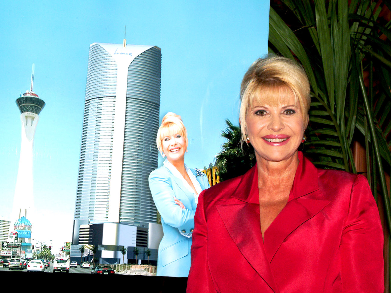 Ivana Trump in a red blazer in front of a photo of herself